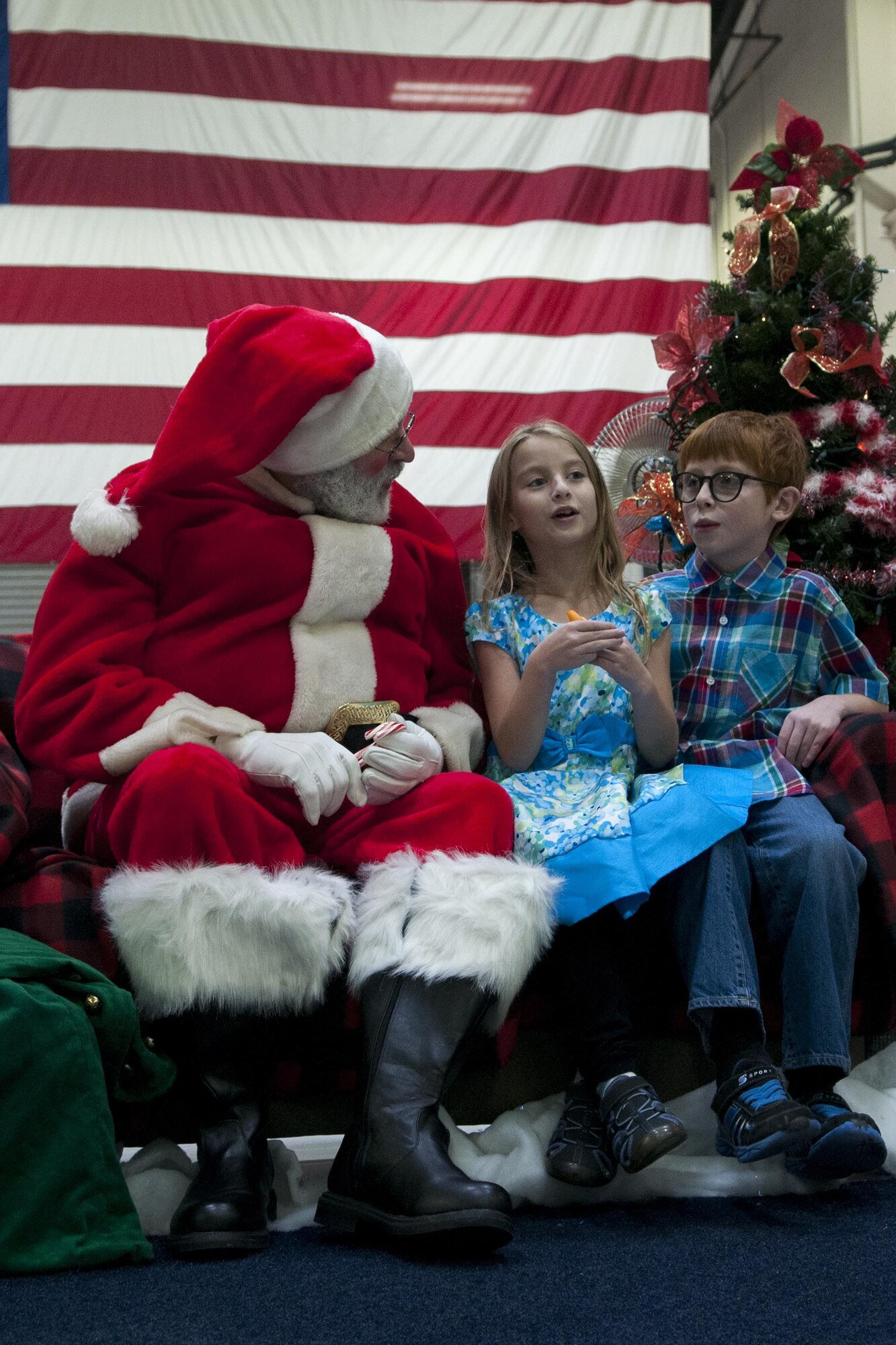 Two children excitedly talk to Santa during the Christmas party at Grissom Air Reserve Base, Ind. on Dec 2, 2017. Every year during the December UTA Grissom hosts a Christmas party for the families of Grissom members. (U.S. Air Force photo/Staff Sgt. Dakota Bergl)
