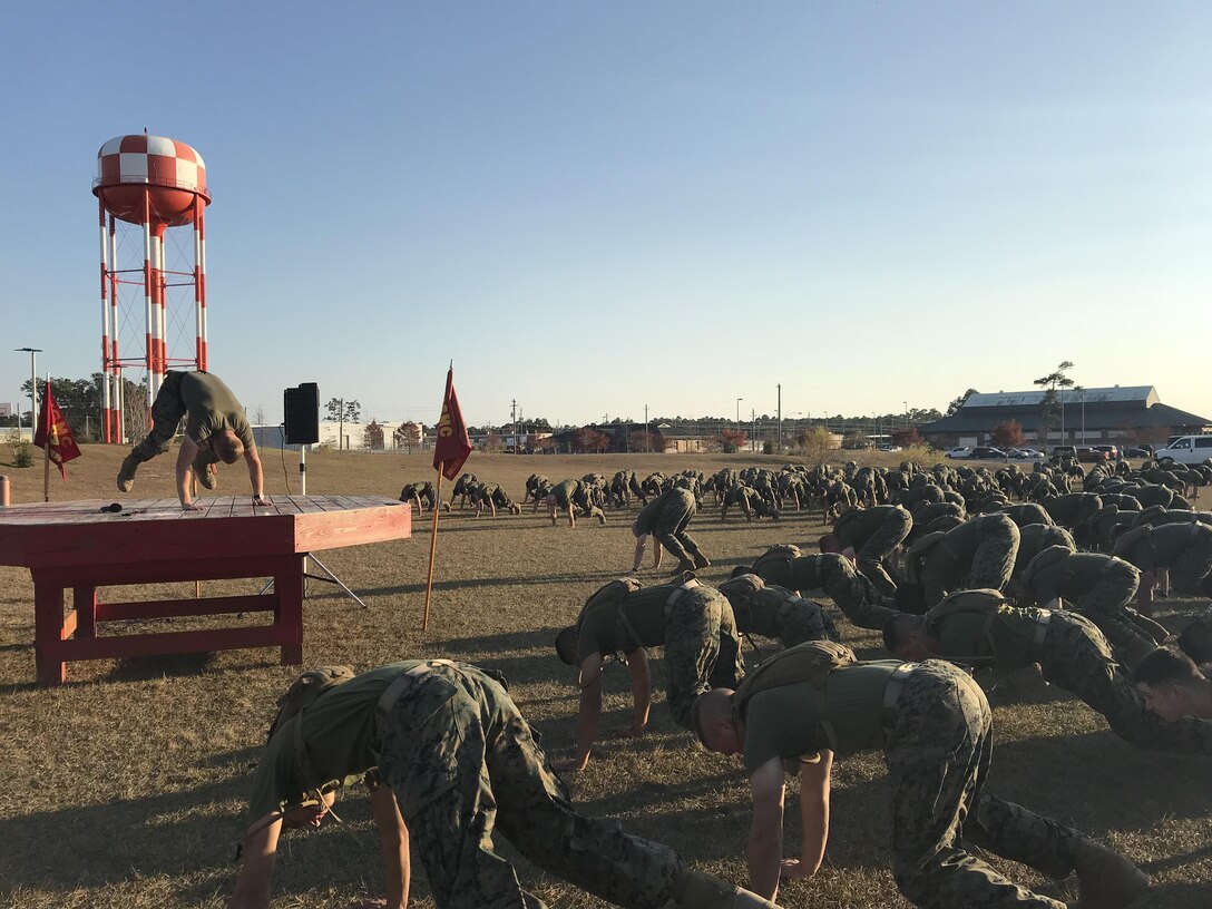 As part of the school physical training session on December 1, 2017 Gunnery Sergeant Lloyd Crabtree, the Force Fitness Instructor (FFI) for Marine Corps Engineer School; leads permanent personnel and students through a modified circuit course.