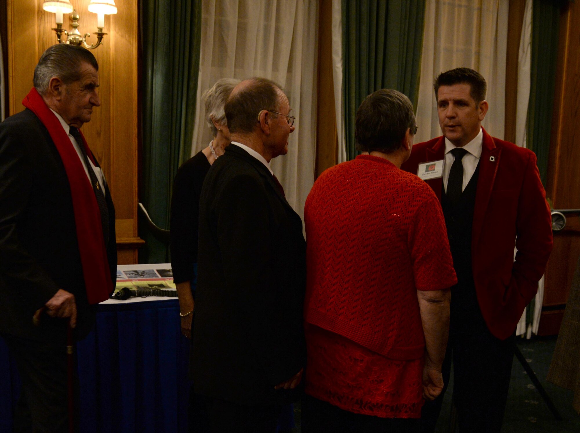 U.S. Air Force Col. Christopher Amrhein, 100th Air Refueling Wing commander, right, greets guests at the Yuletide reception Dec. 1, 2017, hosted on RAF Mildenhall, England. Previous to meeting the commander, guests viewed displays highlighting the missions of the 100th ARW, the 352d Special Operations Wing and the 48th Fighter Wing. (U.S. Air Force photo by Senior Airman Justine Rho)