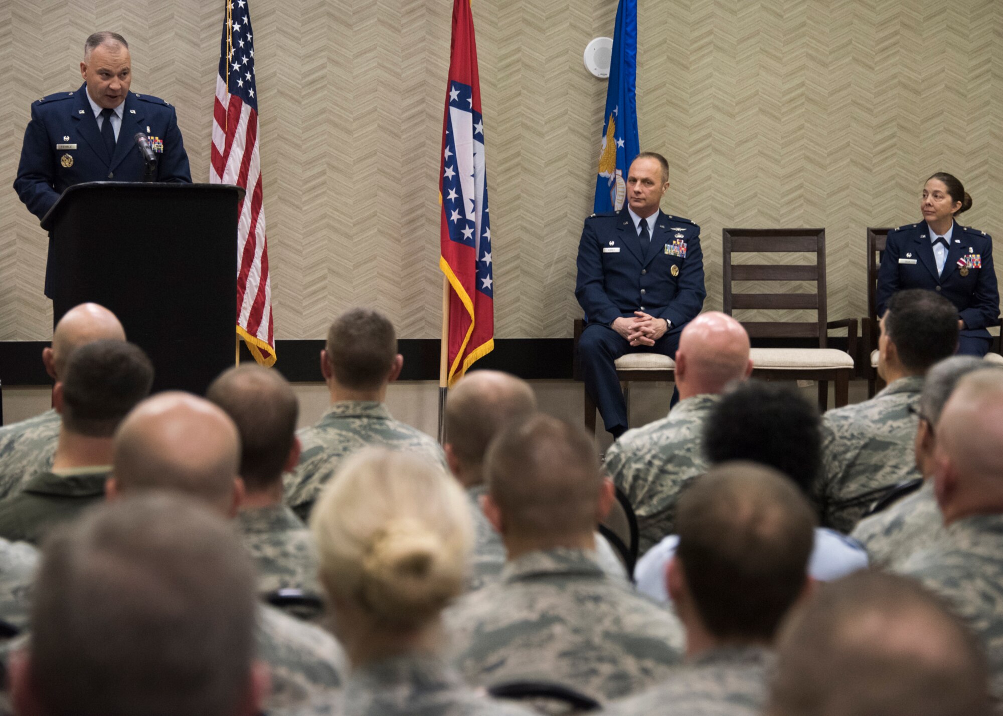 Col. Bret V. Fehrle, Commander 188th Medical Group, addresses audience members after assuming command as Col. Robert I. Kinney, Commander 188th Wing and Col. Misty M. Zelk, former commander 188th Medical Group look on at Fort Smith, AR., Dec. 02, 2017. (U.S. Air National Guard photo by Tech. Sgt. Daniel Condit)