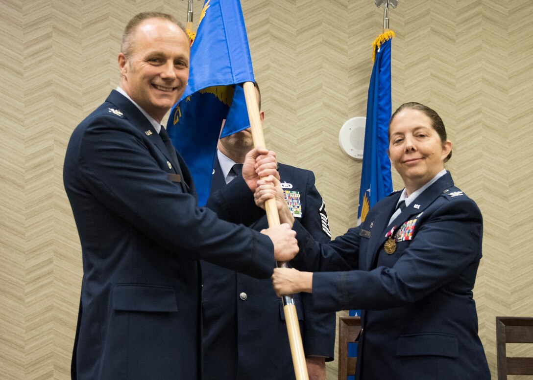 Col. Misty M. Zelk relinquishes command of the 188th Medical Group to Col. Robert I. Kinney, Commander 188th Wing, during a change of command ceremony at Fort Smith, AR., Dec. 02, 2017. The passing of the guidon is a military custom signifying the transfer of command. (U.S. Air National Guard photo by Tech. Sgt. Daniel Condit)