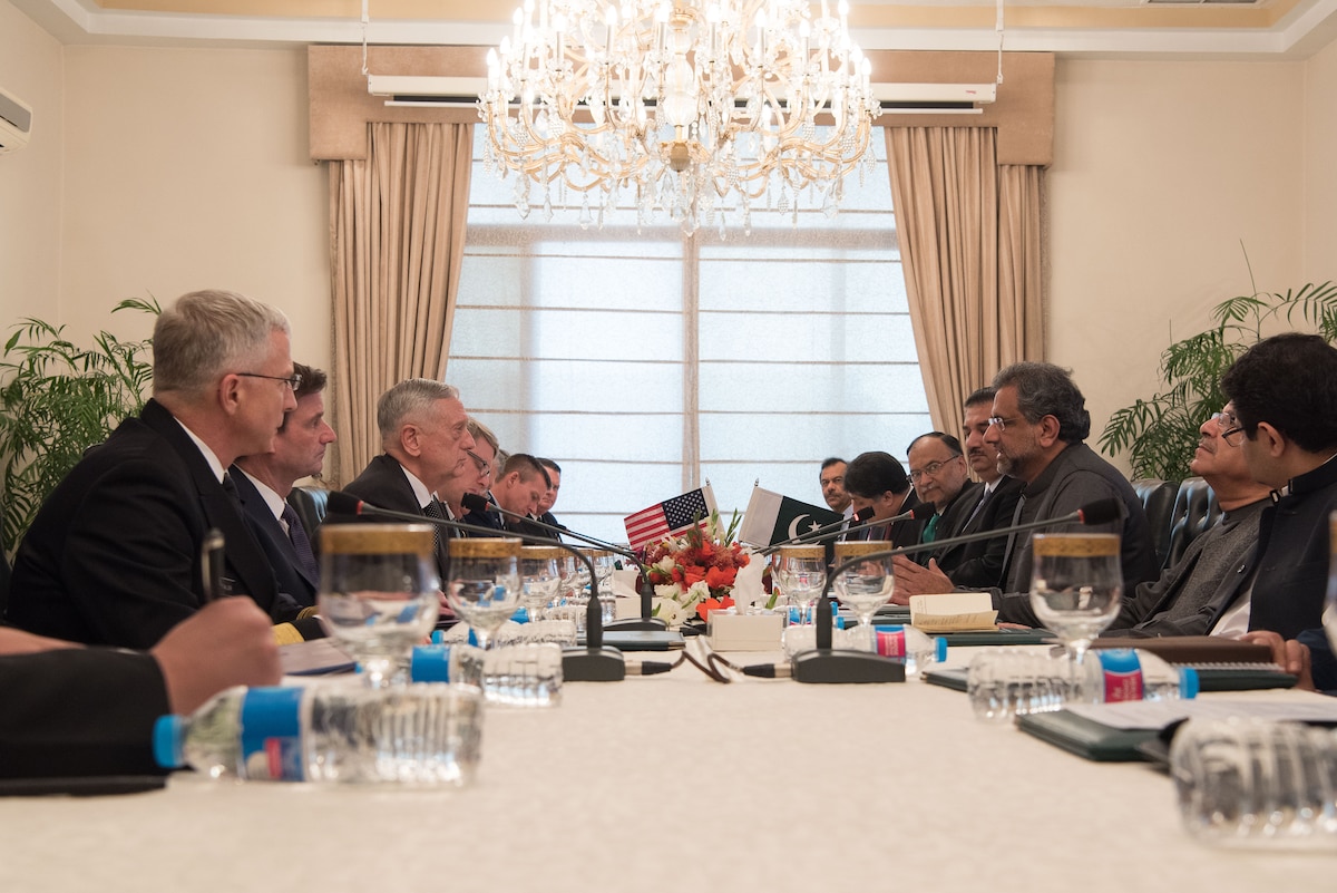 Defense Secretary James N. Mattis and the Pakistani prime minister sit across from each other at a table with other officials.