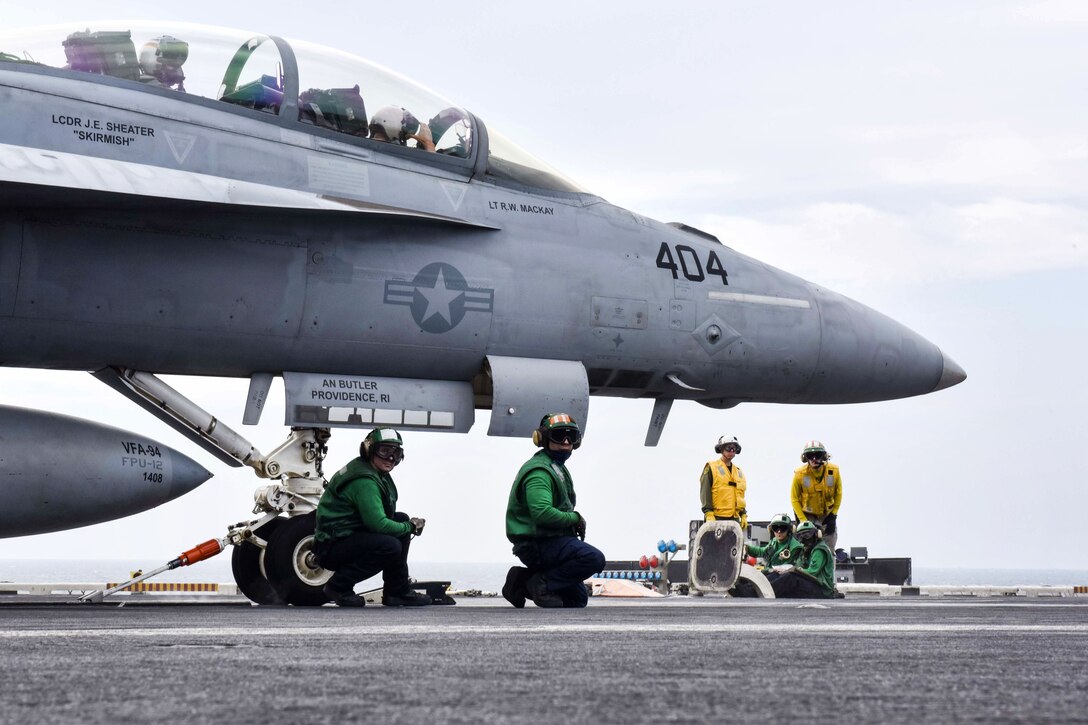 Sailors prepare a F/A-18F Super Hornet aircraft for launch.
