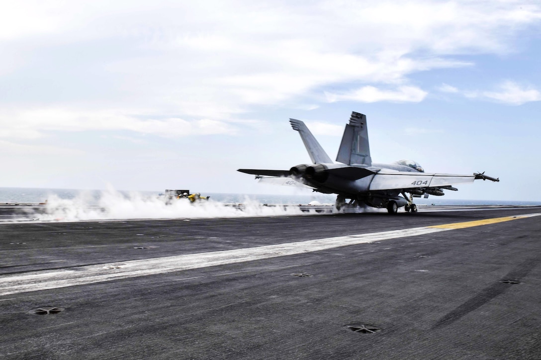 An F/A-18F Super Hornet aircraft launches from the flight deck of the aircraft carrier USS Theodore Roosevelt.