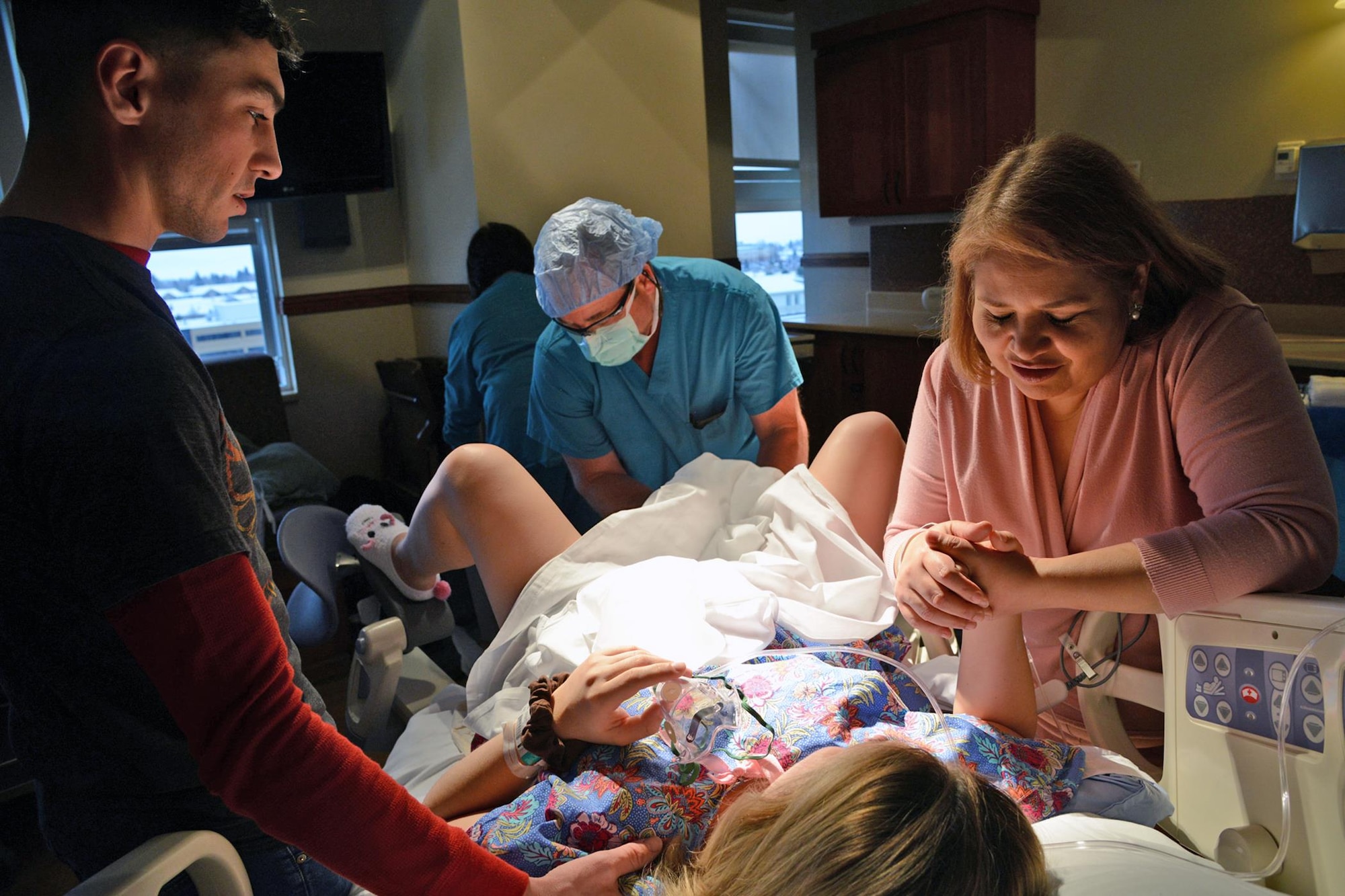 Staff Sgt. Grace Hoyt, 341st Missile Wing chaplain assistant, prepares to give birth to her surrogate baby with her husband, Austin, and the baby’s mother Gabby by her side Nov. 9, 2017, at Benfis Health System, Great Falls, Mont.