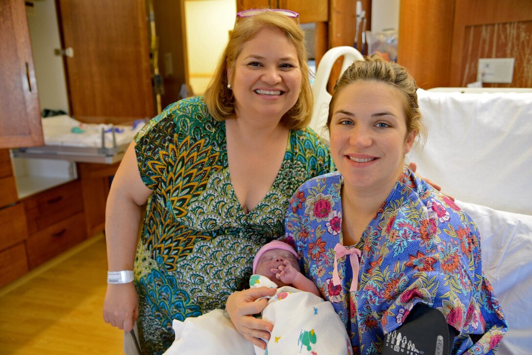 Staff Sgt. Grace Hoyt, 341st Missile Wing chaplain assistant, poses with baby Carolena and mother Gabby Baird Nov. 9, 2017, at Benfis Health System, Great Falls, Mont.