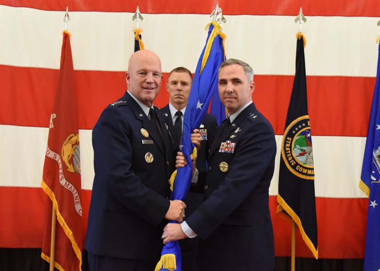 U.S. Air Force Gen. John Raymond, commander of Air Force Space Command, passes the 14th Air Force guide-on to Maj. Gen. Stephen Whiting, the new 14th Air Force commander, during a change of command ceremony, Dec. 1, 2017, Vandenberg Air Force Base, Calif. In addition to the 14th Air Force change of command, the Joint Functional Component Command for Space was deactivated and the Joint Force Space Component Command was activated. The JFSCC will conduct joint space operations to protect and defend the Joint Operations Area and deliver assured theater and global effects in accordance with U.S. Strategic Command’s intent and national and Combatant Commander objectives.