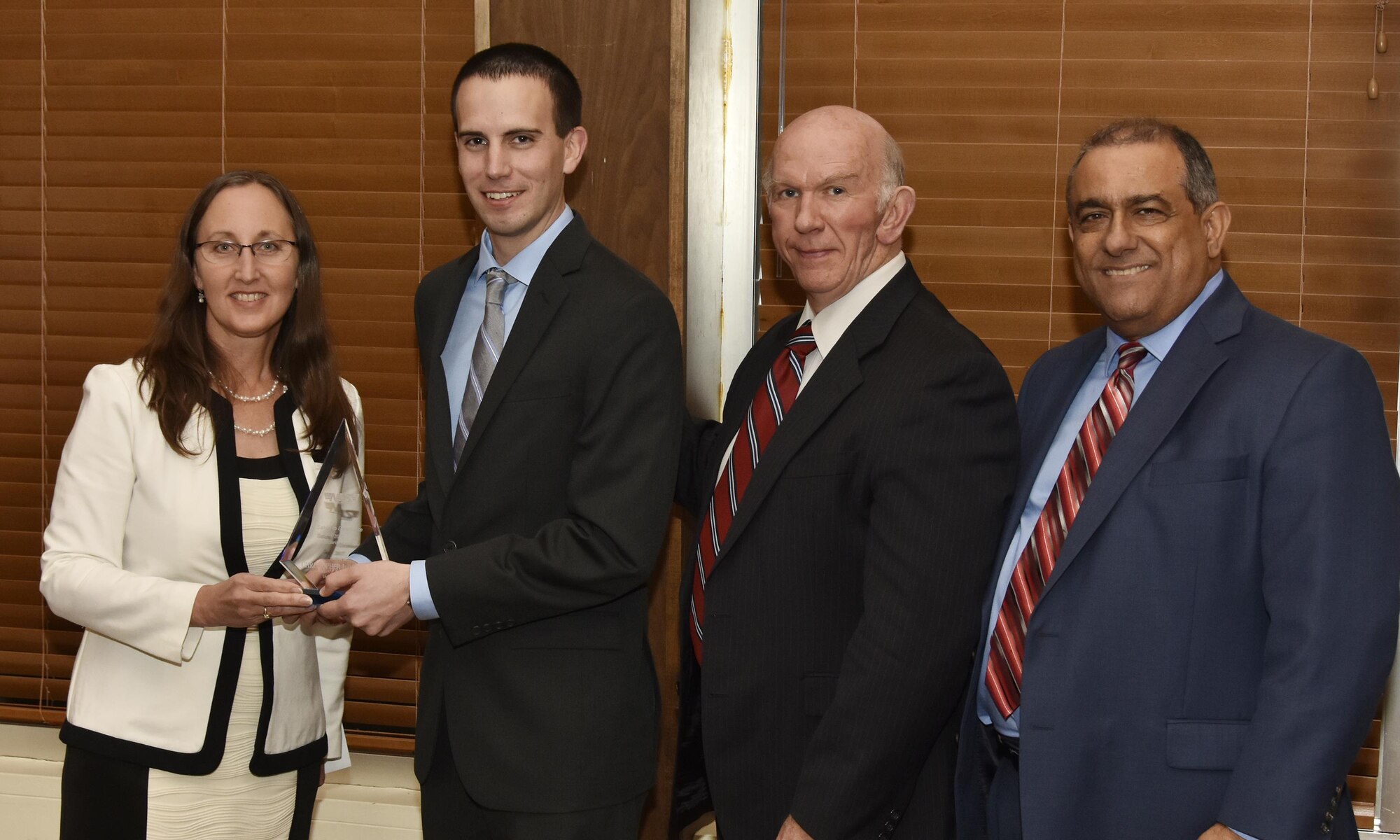 Christopher Bowman, NAS test operations engineer (second from left), receives the Security Award from NAS General Manager Cynthia Rivera during the National Aerospace Solutions 2017 Salute to Excellence Annual Awards Banquet held Nov. 16 at the Arnold Lakeside Center, Arnold Air Force Base, Tenn. NAS Deputy General Manager Doug Pearson and NAS Business Services Manager Mike Lugo pictured at right. (U.S. Air Force photo/Rick Goodfriend)