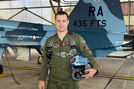 Capt. Joshua Smith, 435th Fighter Training Squadron flight commander and instructor pilot, stands by the tail of a T-38C Talon Sept. 20, 2017, at Joint Base San Antonio-Randolph, Texas. Smith Relied on his training to overcome the failure of one his T-38's engines and guided the aircraft to an airfield for a safe landing. (courtesy photo)