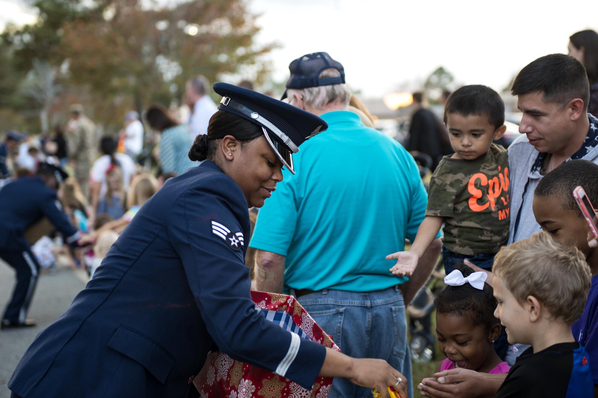 Senior Airman Jamie Smith, Moody Air Force Base ceremonial guardsman, passes out candy during a parade at the Tree Lighting Ceremony, Dec. 1, 2017, at Moody AFB, Ga. The annual event brings the base community together as a way to show thanks for their continuous sacrifice and celebrate the holiday season. The celebration included a parade, raffle give-a-ways, children’s activities and traditional lighting of the base Christmas tree by families of deployed Airmen. (U.S. Air Force photo by Airman 1st Class Erick Requadt)
