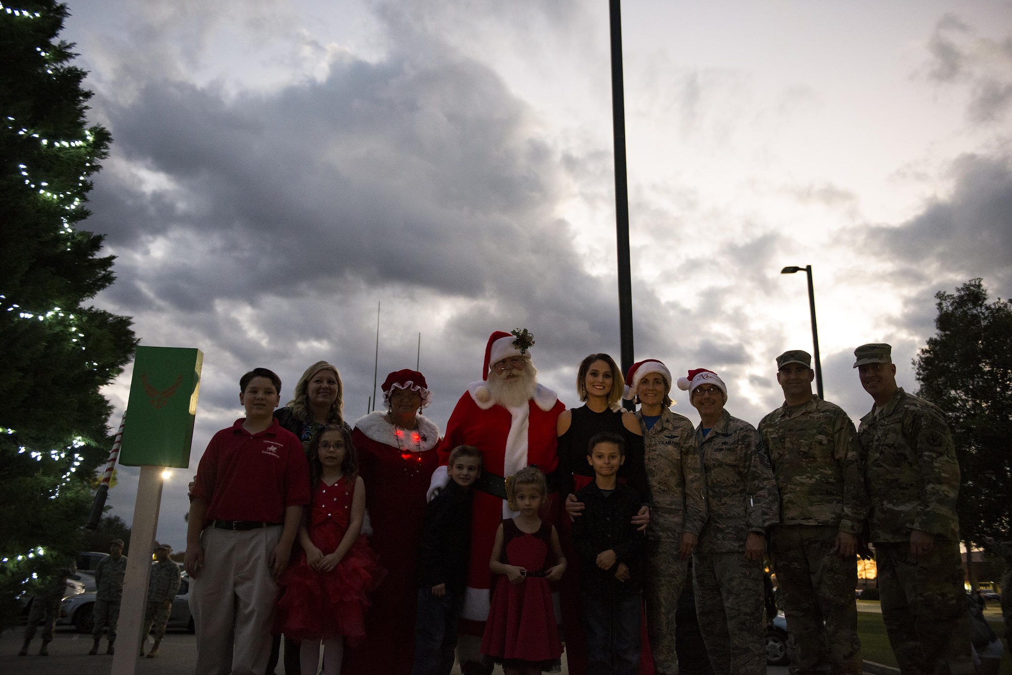 Members of Team Moody along with Santa and Mrs. Claus pose for a photo during the Tree Lighting Ceremony, Dec. 1, 2017, at Moody Air Force Base, Ga. The annual event brings the base community together as a way to show thanks for their continuous sacrifice and celebrate the holiday season. The celebration included a parade, raffle give-a-ways, children’s activities and traditional lighting of the base Christmas tree by families of deployed Airmen. (U.S. Air Force photo by Airman 1st Class Erick Requadt)