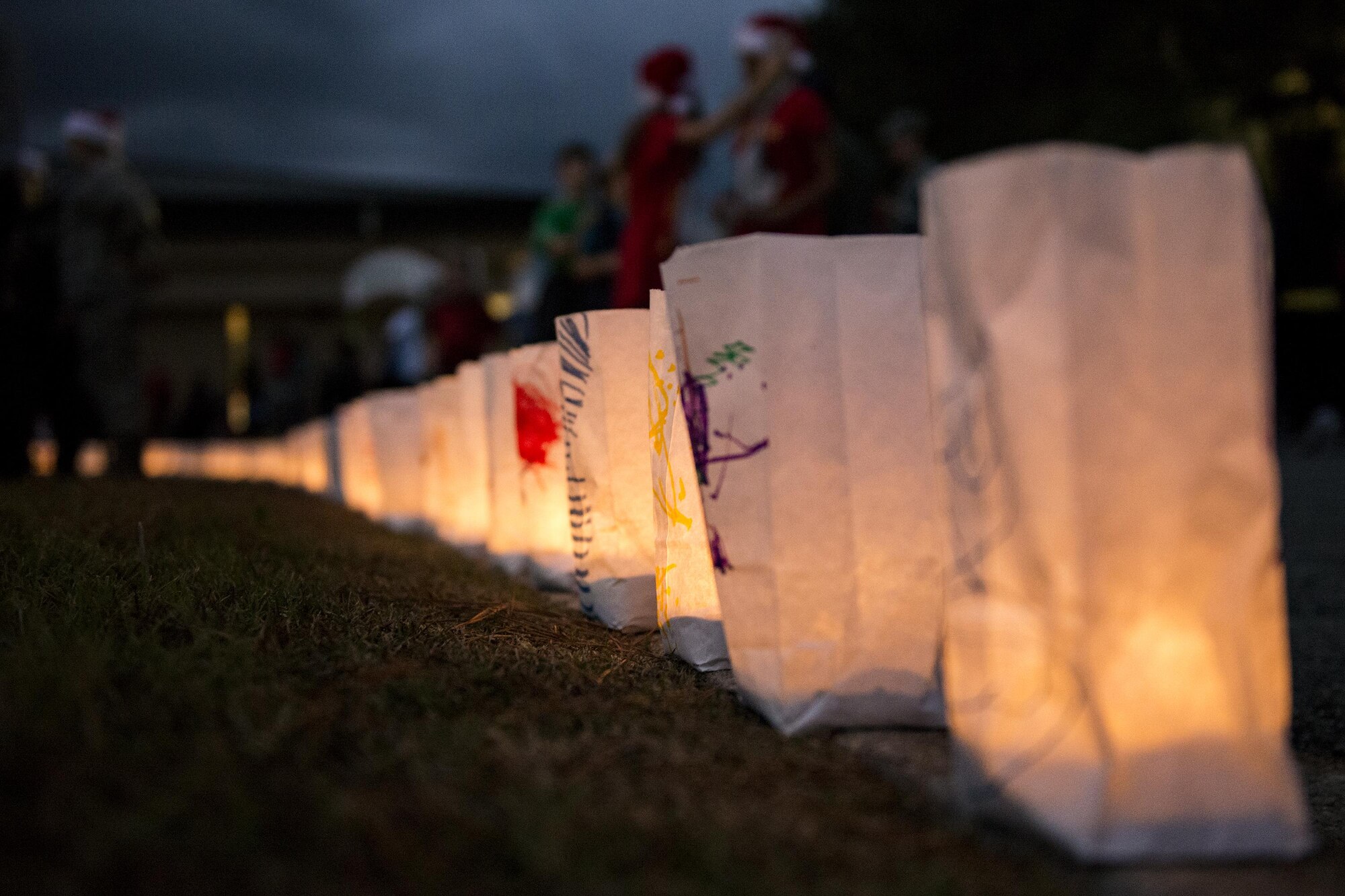 Illuminated paper bags rest on a curb during the Tree Lighting Ceremony, Dec. 1, 2017, at Moody Air Force Base, Ga. The annual event brings the base community together as a way to show thanks for their continuous sacrifice and celebrate the holiday season. The celebration included a parade, raffle give-a-ways, children’s activities and traditional lighting of the base Christmas tree by families of deployed Airmen. (U.S. Air Force photo by Airman 1st Class Erick Requadt)