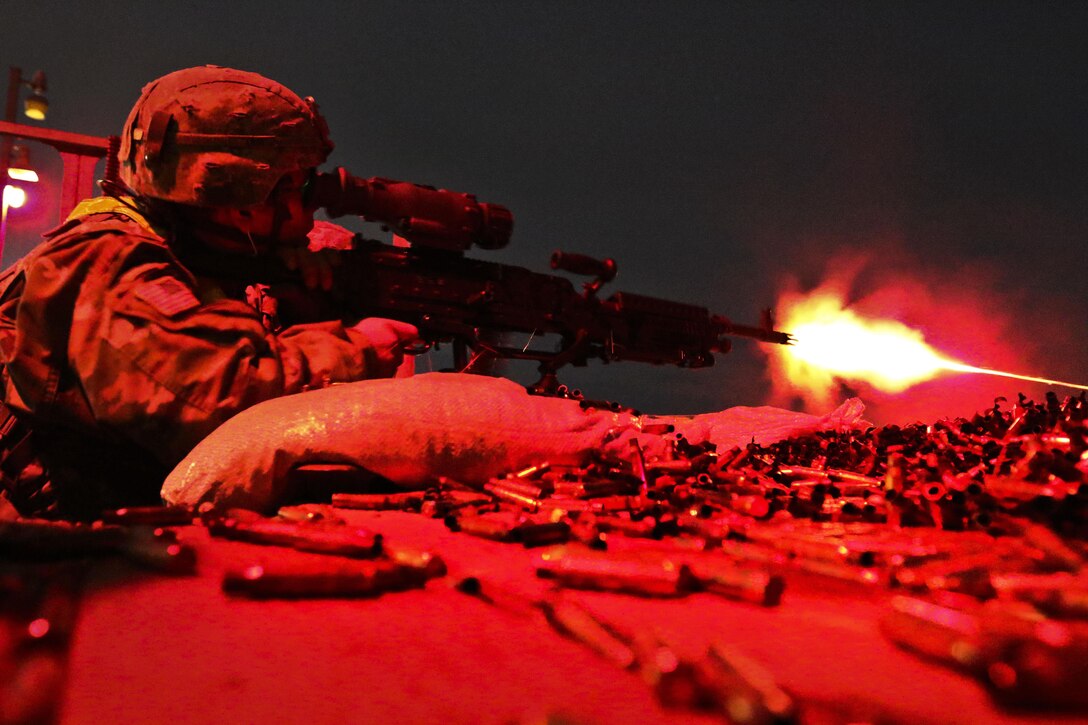 Spc. Christopher Landon fires an M240B machine gun during Operation Cold Steel II
