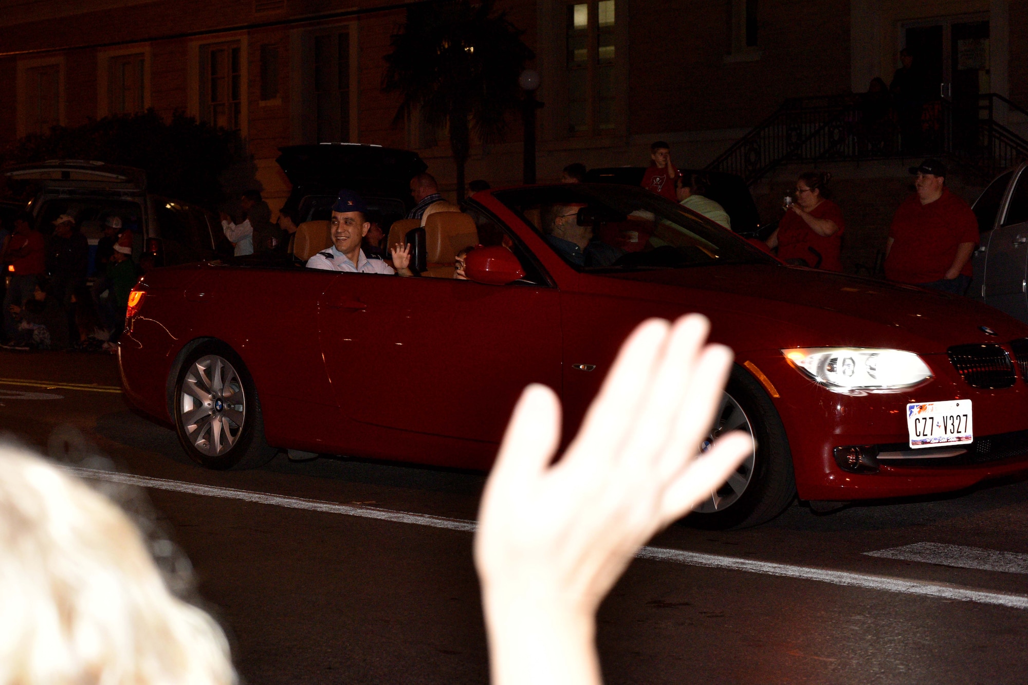 U.S. Air Force Col. Ricky Mills, 17th Training Wing commander, waves to spectators during the 17th annual Lights of Christmas Parade in San Angelo, Texas, Dec. 2, 2017. Multiple churches, businesses, organizations, clubs and schools decorated trucks, trailers and floats for the Concho Christmas celebration. U.S Air Force Photo by Airman 1st Class Randall Moose/Released)