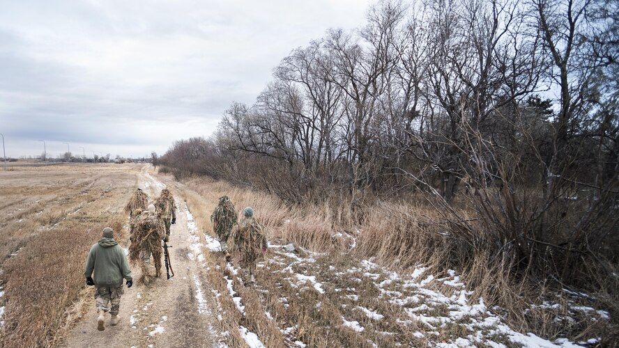Defenders from the 791st Missile Security Forces Squadron search for hiding locations during joint-unit training at Minot Air Force Base, N.D., Nov. 22, 2017. During the joint-unit training, 791 MSFS defenders evaded capture by 5th Security Forces Squadron K9s and their handlers. (U.S. Air Force photo by Senior Airman J.T. Armstrong)