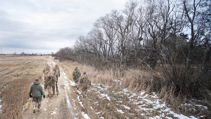 Defenders from the 791st Missile Security Forces Squadron search for hiding locations during joint-unit training at Minot Air Force Base, N.D., Nov. 22, 2017. During the joint-unit training, 791 MSFS defenders evaded capture by 5th Security Forces Squadron K9s and their handlers. (U.S. Air Force photo by Senior Airman J.T. Armstrong)