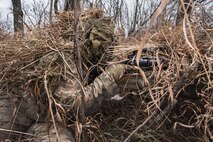 A 791st Missile Security Forces Squadron marksman looks through his rifle scope during joint-unit training at Minot Air Force Base, N.D., Nov. 22, 2017. During training, marksmen teams observed a 5th Security Forces Squadron military working dog team while gathering intelligence and avoiding detection. (U.S. Air Force photo by Senior Airman J.T. Armstrong)