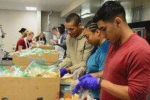Airmen from Malmstrom Air Force Base prepare meals for the senior community Nov. 22, 2017, in Great Falls, Mont. Airmen evenly dispersed nearly 600 meals for Meals on Wheels to include desserts, bread and cranberry sauce. (U.S. Air Force photo by Airman 1st Class Tristan Truesdell)