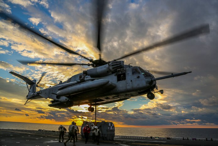 A U.S. Marine Corps CH-53E Super Stallion helicopter with Marine Medium Tiltrotor Squadron (VMM) 162 (Reinforced), 26th Marine Expeditionary Unit (MEU), picks up an AV-8B Harrier engine to transport it from the amphibious assault ship USS Iwo Jima (LHD 7) to the fleet replenishment ship USNS Big Horn (T-AO-198) during a Helicopter Support Team mission as part of Combined Composite Training Unit Exercise (COMPTUEX), Dec. 1, 2017, in the Atlantic Ocean. The exercise allows all elements of the Marine Air Ground Task Force (MAGTF) to join and train in realistic scenarios so the MEU as a whole can meet its Pre-Deployment Training Program objectives prior to their upcoming deployment at sea.