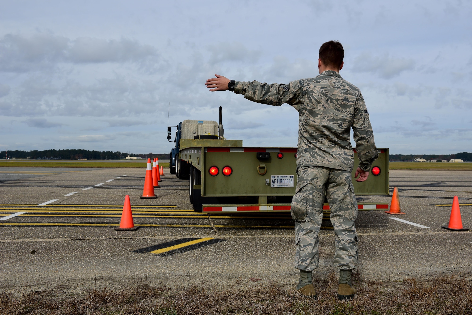 Airman 1st Class Cole Dredge, 4th Logistics Readiness Squadron vehicle operator, helps direct a tractor trailer into a parking spot during training, Nov. 21, 2017, at Seymour Johnson Air Force Base, North Carolina. During the 336th Fighter Squadron’s deployment, October 2017, two Airmen drove a tractor trailer containing 16,000 pounds of equipment from Seymour Johnson AFB to Canadian Forces Base Greenwood, Nova Scotia, Canada to provide parts for diverted aircraft. (U.S. Air Force photo by Airman 1st Class Kenneth Boyton)