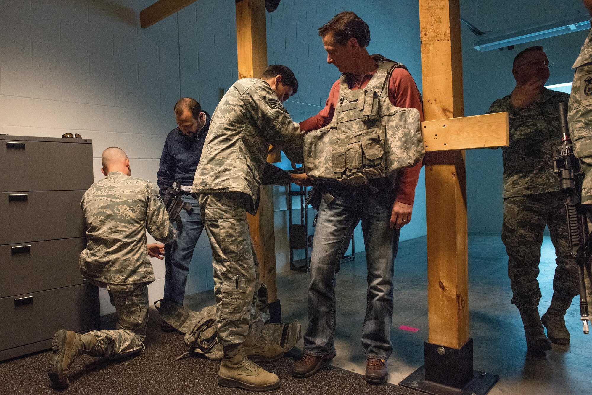 Honorary commanders Chris Passaro and James Meyer get assistance from members of the 934th Security Forces Squadron in gearing up to experience the Military Interactive Learning Objectives system at the Minneapolis-St. Paul Air Reserve Station, MN on Dec. 3, 2017.  The MILO is a computer-based simulation training system used to train Airmen to react in shoot-no-shoot scenarios. (U.S. Air Force photo by Master. Sgt. Eric Amidon)