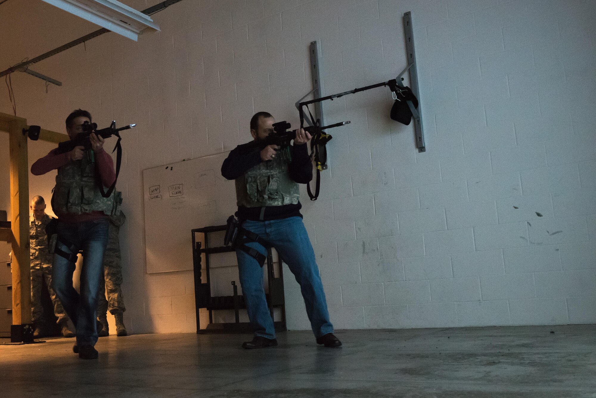 Honorary commanders Chris Passaro and James Meyer experience first-hand how to react during shoot-no-shoot scenarios using the Military Interactive Learning Objectives system at the Minneapolis-St. Paul Air Reserve Station, MN on Dec. 3, 2017.  They were able to experience multiple simulated scenarios Airmen may experience on deployments or while defending installation assets and perimeters. (U.S. Air Force photo by Master. Sgt. Eric Amidon)