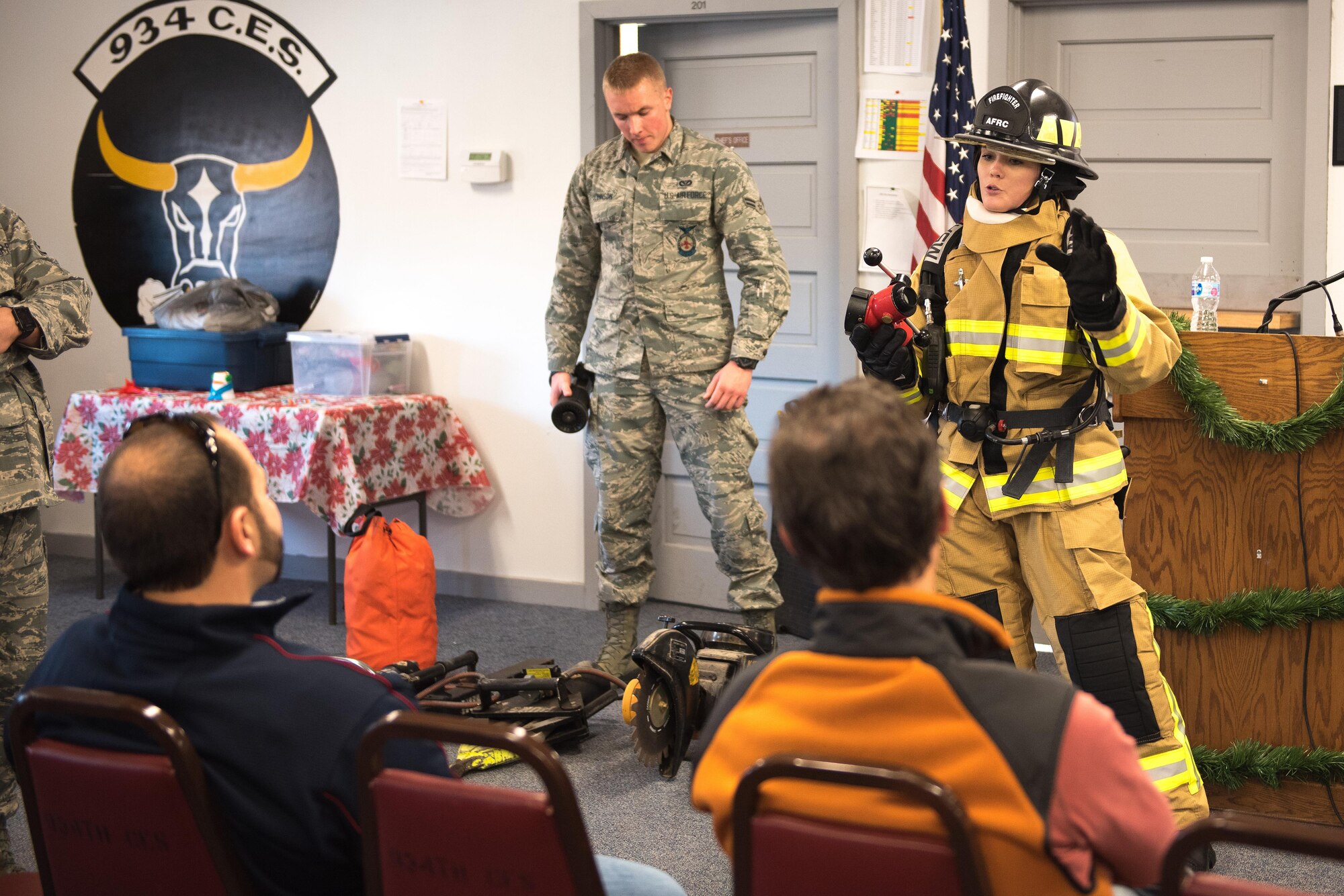 Airman Rachel Hagen, fire protection specialist for the 934th Civil Engineering Squadron demonstrated the proper wear of the fire protection equipment and the various tools used that contribute to the effective fire suppression capabilities at the Minneapolis-St. Paul Air Reserve Station, MN on Dec. 3, 2017.  The  participants were afforded the opportunity to try on the gear and handle many of the tools on display. (U.S. Air Force photo by Master. Sgt. Eric Amidon)