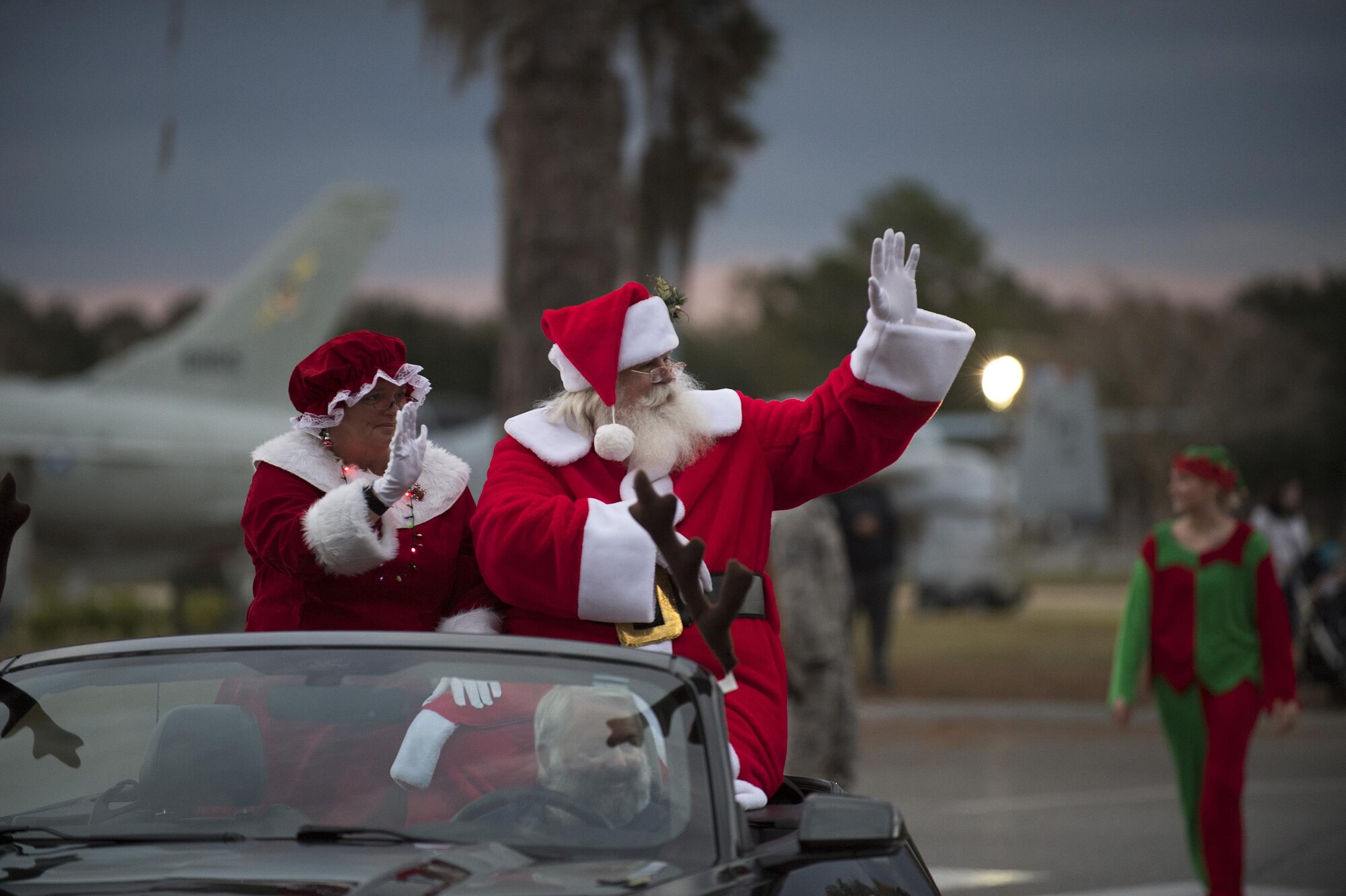 Santa and Mrs. Claus wave during a parade, Dec. 1, 2017, at Moody Air Force Base, Ga. The annual event brings the base community together as a way to show thanks for their continuous sacrifice and celebrate the holiday season. The celebration included a parade, raffle give-a-ways, children’s activities and traditional lighting of the base Christmas tree by families of deployed Airmen. (U.S. Air Force photo by Andrea Jenkins)
