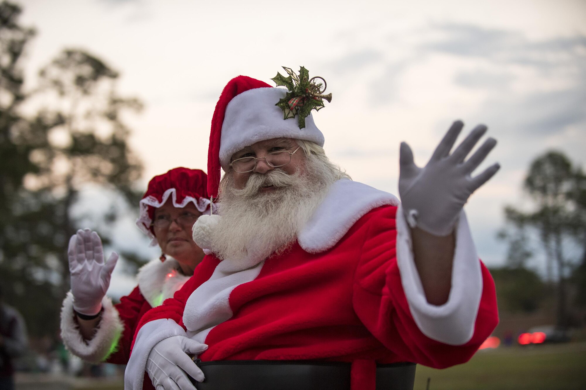 Santa and Mrs. Claus wave during a parade, Dec. 1, 2017, at Moody Air Force Base, Ga. The annual event brings the base community together as a way to show thanks for their continuous sacrifice and celebrate the holiday season. The celebration included a parade, raffle give-a-ways, children’s activities and traditional lighting of the base Christmas tree by families of deployed Airmen. (U.S. Air Force photo by Andrea Jenkins)