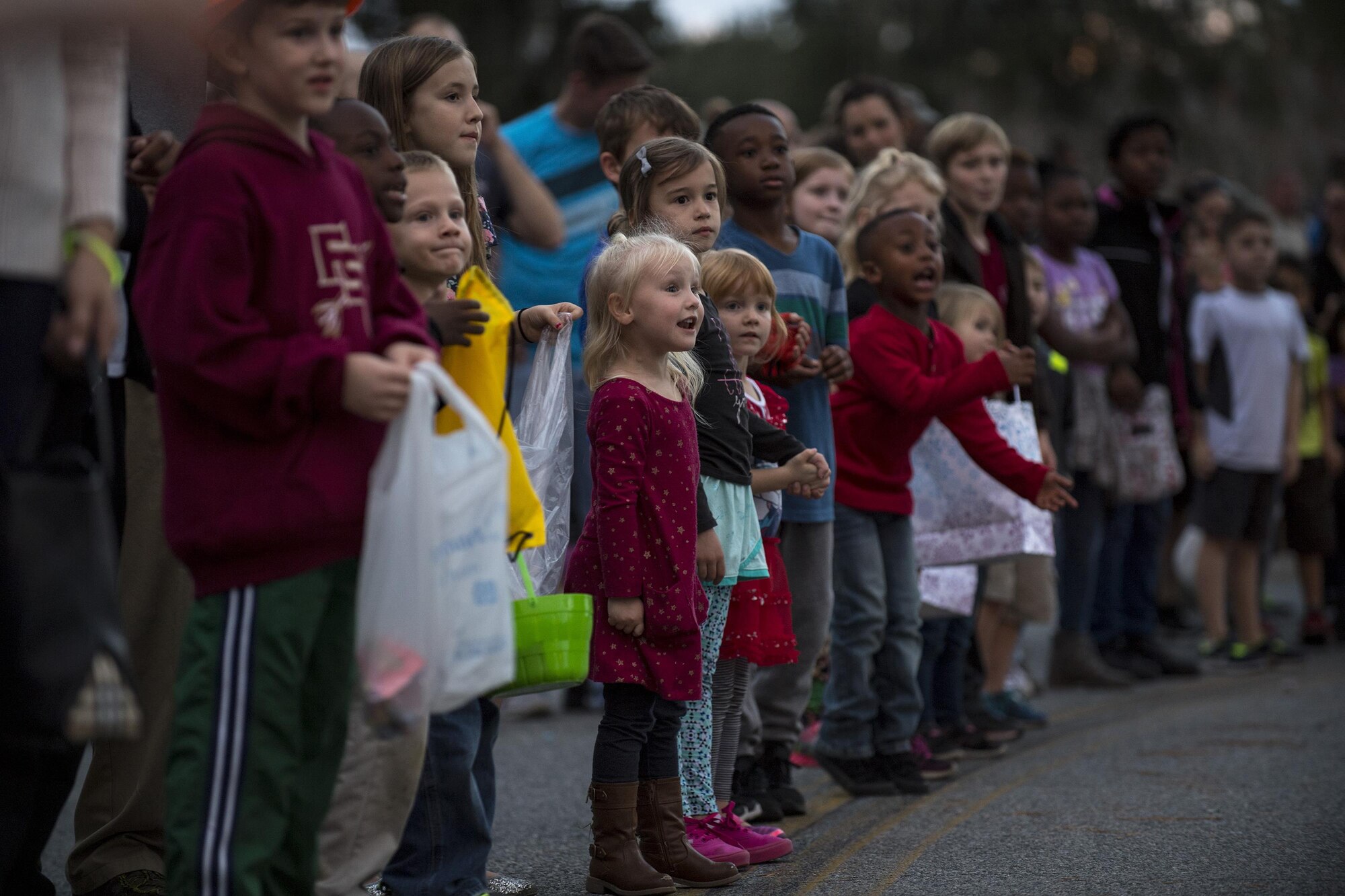 Children watch as the parade goes by, Dec. 1, 2017, at Moody Air Force Base, Ga. The annual event brings the base community together as a way to show thanks for their continuous sacrifice and celebrate the holiday season. The celebration included a parade, raffle give-a-ways, children’s activities and traditional lighting of the base Christmas tree by families of deployed Airmen. (U.S. Air Force photo by Andrea Jenkins)