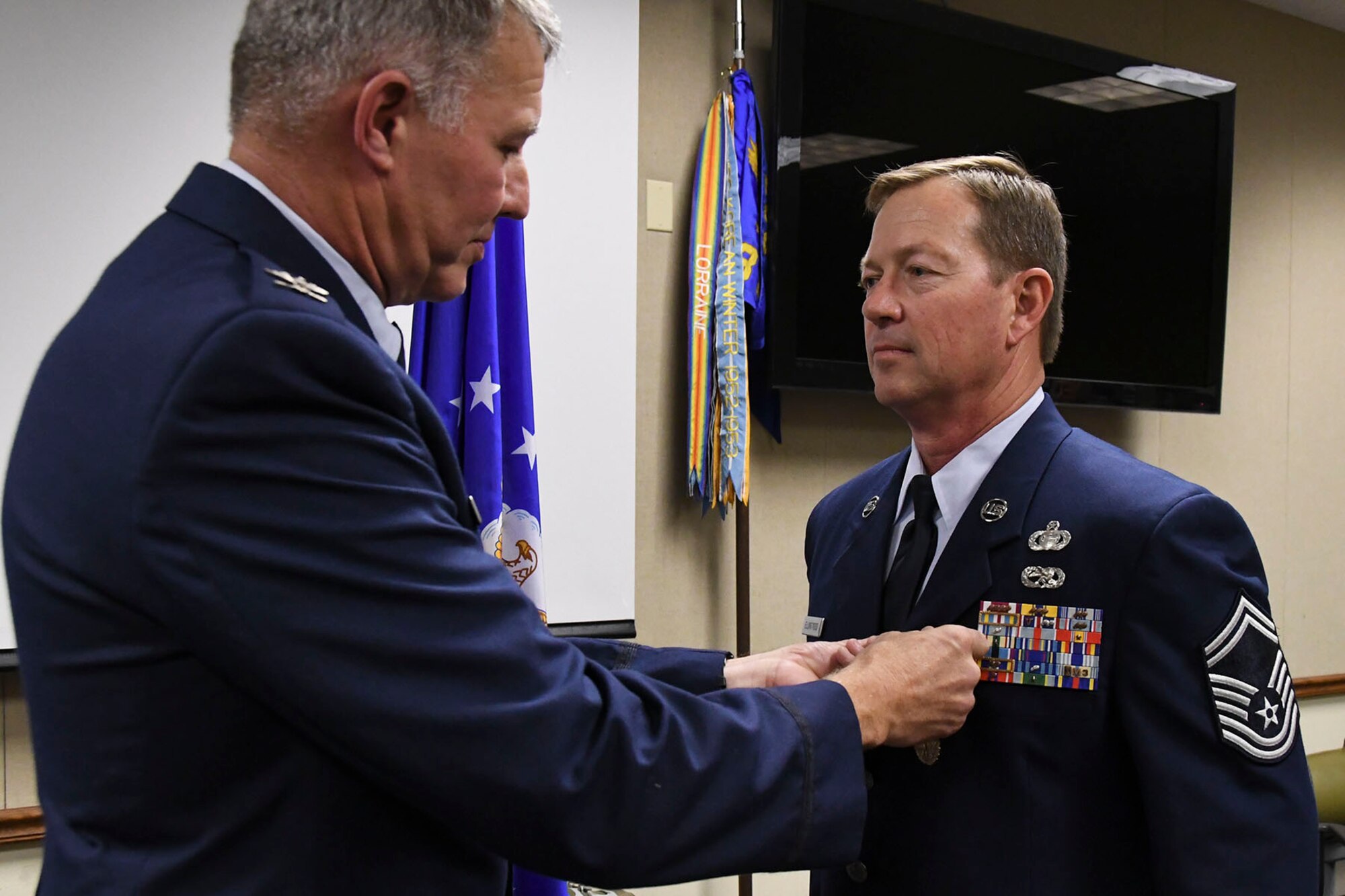 U.S. Air Force Col. Robert VanHoy II, 307th Bomb Wing commander presents the Meritorious Service Medal to Senior Master Sgt. Darren Ellingwood, 307th Operations Support Squadron intelligence superintendent, during his retirement ceremony at Barksdale Air Force Base, La., Dec. 2, 2017.