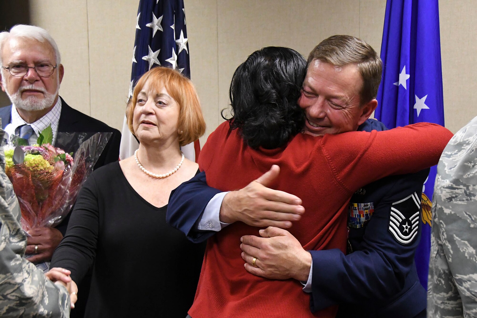 U.S. Air Force Senior Master Sgt. Darren Ellingwood, 307th Operations Support Squadron intelligence superintendent, embraces a coworker at the conclusion of his retirement ceremony at Barksdale Air Force Base, La., Dec. 2, 2017.