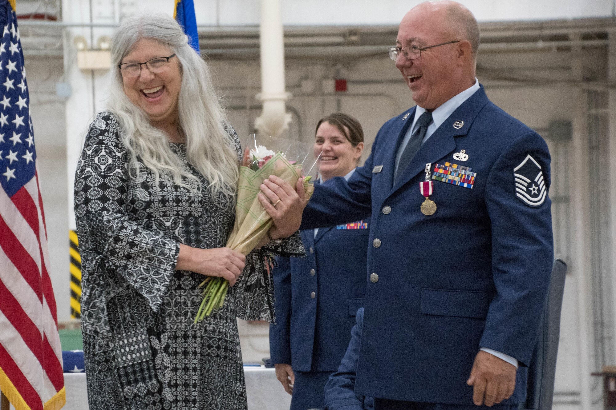 U.S. Air Force Master Sgt. Edward Fairchild, 707th Maintenance Squadron aircraft technician expeditor, presents flowers to his wife, Nadine Fairchild, during his retirement ceremony on Barksdale Air Force Base, La., Dec. 2, 2017.