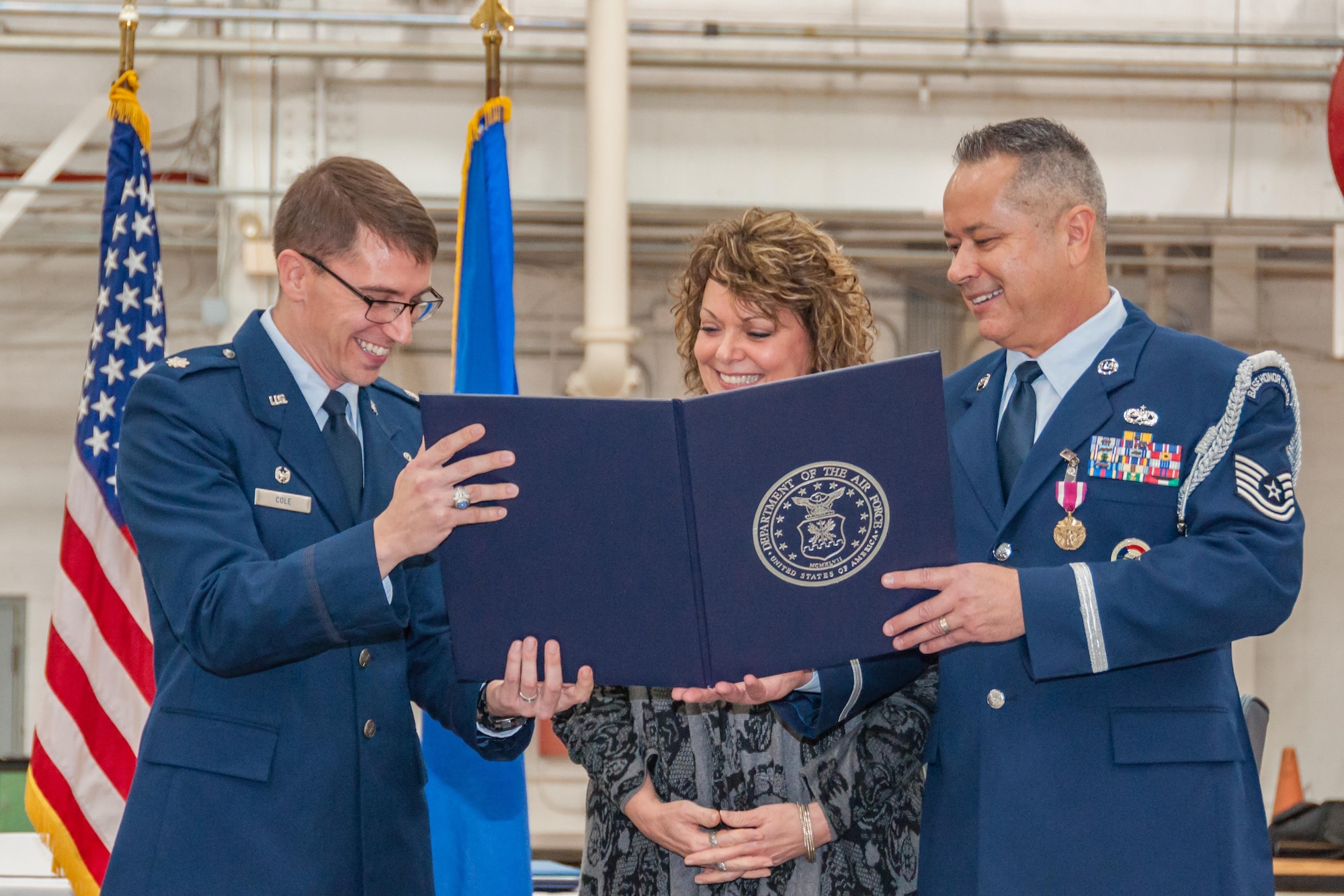 U.S. Air Force Lt. Col. George Cole, 307th Maintenance Squadron commander, and Tech. Sgt. Christopher Marien, 307th MXS Aerospace Ground Equipment mechanic, presents Marien’s wife, Sheri, with a certificate of appreciation during Marien’s retirement ceremony on Barksdale Air Force Base, La., Dec. 2, 2017.