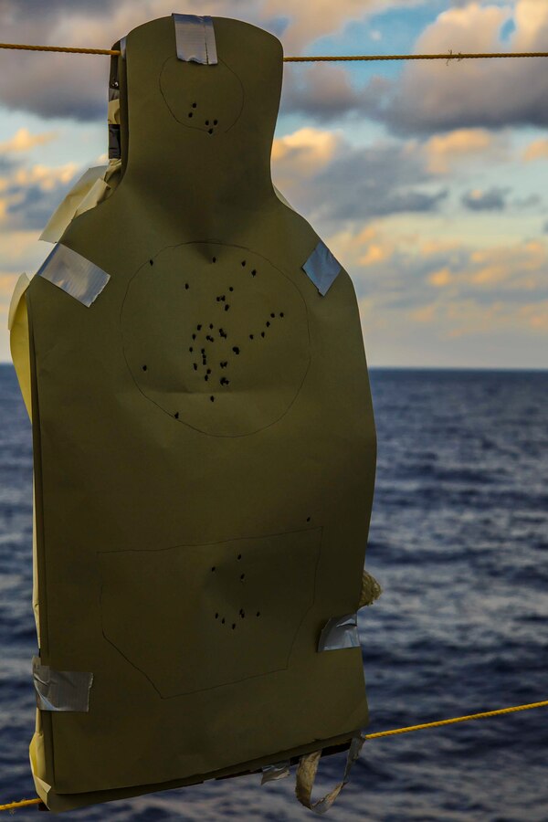 A target riddled with holes hangs after U.S. Marines with Fox Company, Battalion Landing Team, 2nd Battalion, 6th Marine Regiment, 26th Marine Expeditionary Unit (MEU), conducted combat marksmanship training on the flight deck of the dock landing ship USS Oak Hill (LSD 51), in the Atlantic Ocean, Dec. 3, 2017, as part of Combined Composite Training Unit Exercise (COMPTUEX). Combined COMPTUEX allows all elements of the Marine Air Ground Task Force to join and train in realistic scenarios so the MEU as a whole can meet its Predeployment Training Program objectives prior to an upcoming deployment at sea. (U.S. Marine Corps photo by Staff Sgt. Dengrier M. Baez)