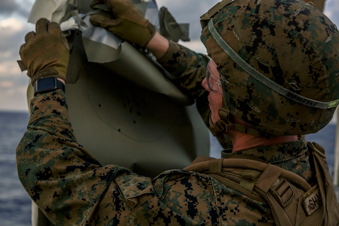 U.S. Marines with Fox Company, Battalion Landing Team, 2nd Battalion, 6th Marine Regiment, 26th Marine Expeditionary Unit (MEU), engage targets during combat marksmanship training on the flight deck of the dock landing ship USS Oak Hill (LSD 51), in the Atlantic Ocean, Dec. 3, 2017, as part of Combined Composite Training Unit Exercise (COMPTUEX).