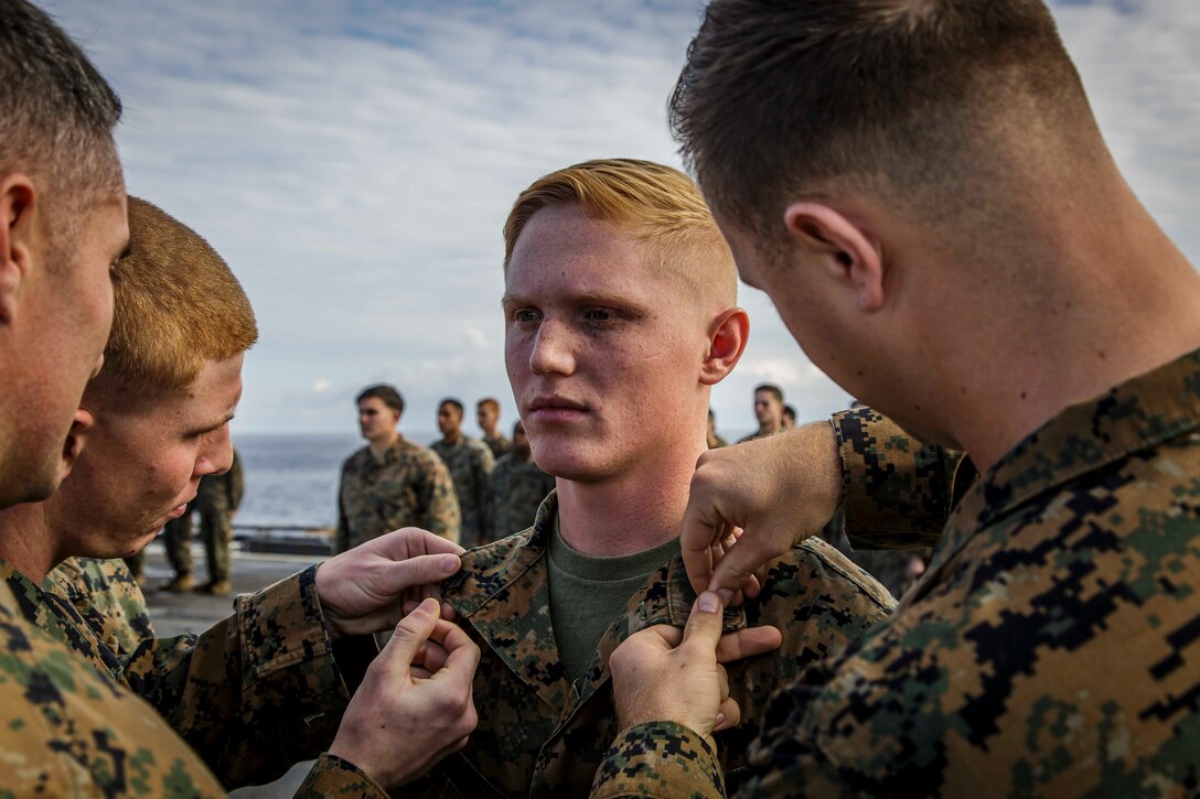 U.S. Marine Corps Cpl. Brett M. Shakofsky, center, an infantry Marine with Fox Company, Battalion Landing Team, 2nd Battalion, 6th Marine Regiment, 26th Marine Expeditionary Unit (MEU), is meritoriously promoted to his current rank during a ceremony aboard the dock landing ship USS Oak Hill (LSD 51) in the Atlantic Ocean, Dec. 1, 2017, during Combined Composite Training Unit Exercise (COMPTUEX). Combined COMPTUEX allows all elements of the Marine Air Ground Task Force to join and train in realistic scenarios so the MEU as a whole can meet its Predeployment Training Program objectives prior to an upcoming deployment at sea. (U.S. Marine Corps photo by Staff Sgt. Dengrier M. Baez)
