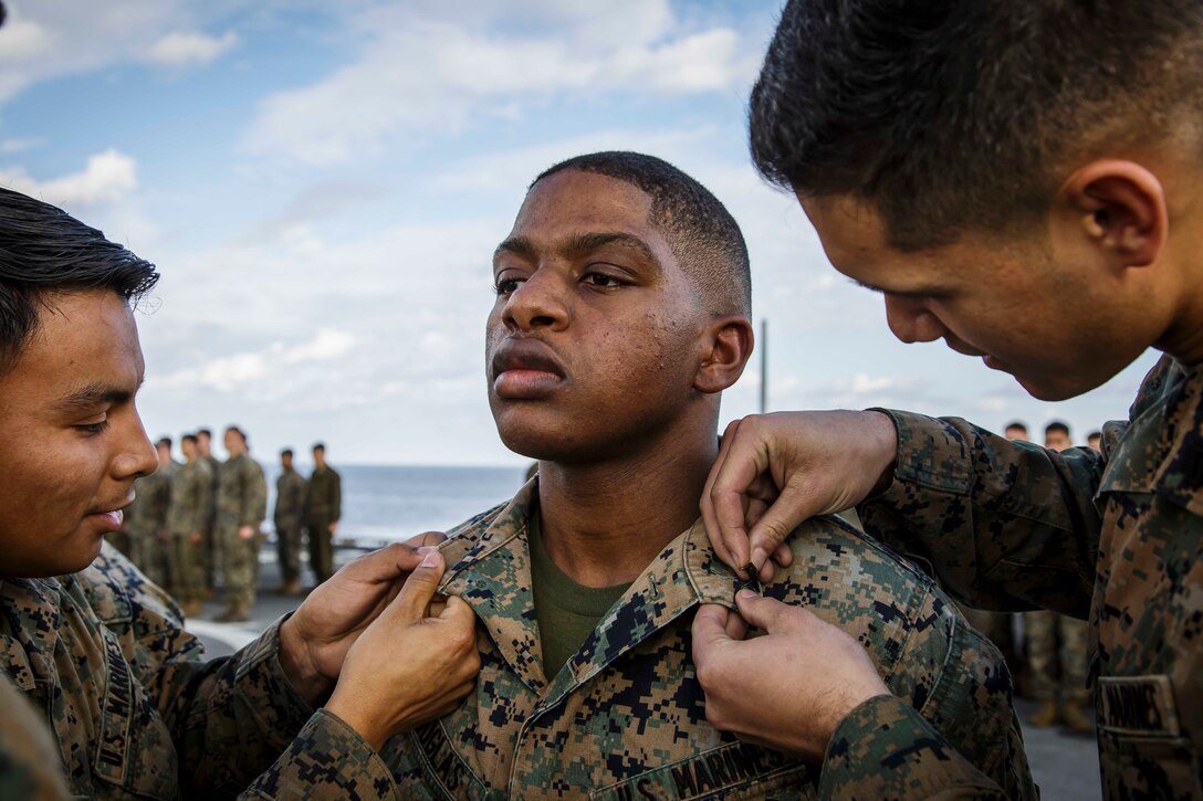 U.S. Marine Corps Cpl. Dallin E. Douglas Jr., a food service specialist with Fox Company, Battalion Landing Team, 2nd Battalion, 6th Marine Regiment, 26th Marine Expeditionary Unit (MEU), is promoted to his current rank during a ceremony aboard the dock landing ship USS Oak Hill (LSD 51) in the Atlantic Ocean, Dec. 1, 2017, during Combined Composite Training Unit Exercise (COMPTUEX). Combined COMPTUEX allows all elements of the Marine Air Ground Task Force to join and train in realistic scenarios so the MEU as a whole can meet its Predeployment Training Program objectives prior to an upcoming deployment at sea. (U.S. Marine Corps photo by Staff Sgt. Dengrier M. Baez)