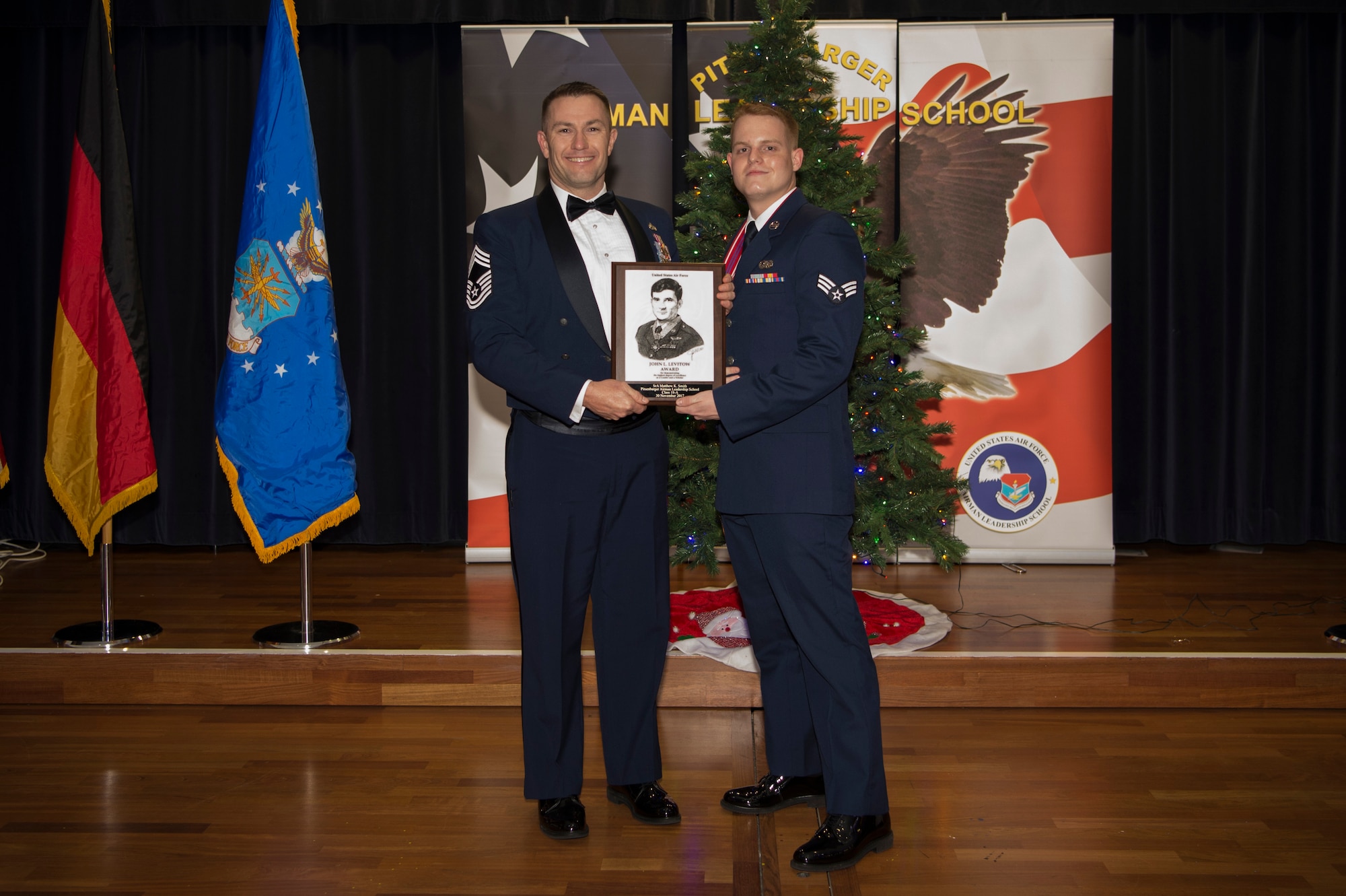 U.S. Air Force Senior Airman Matthew Smith, 52nd Communications Squadron mission defense team technician, receives the John L. Levitow during the Pitsenbarger Airman Leadership School 18-A graduation at Club Eifel on Spangdahlem Air Base, Germany, November 30,2017. The Levitow award is the highest honor given to the student who displays excellence in all categories of ALS. (U.S. Air Force photo by Senior Airman Dawn M. Weber)