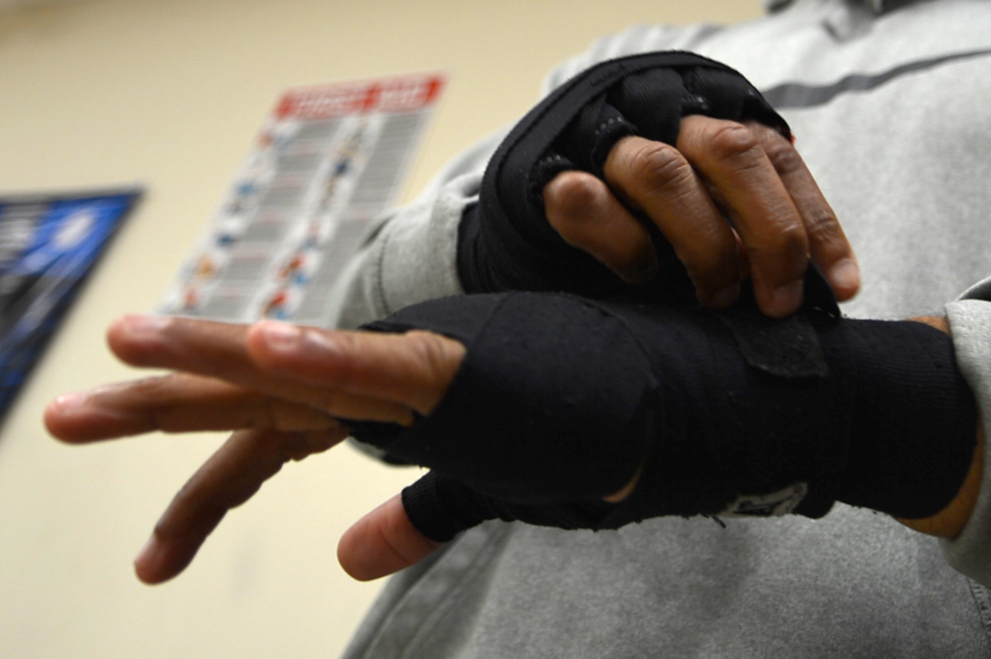 U.S. Air Force Tech. Sgt. Andre Penn, 20th Civil Engineer Squadron unaccompanied housing manager, wraps his hands prior to training at Team Robinson Mixed Martial Arts in Sumter, South Carolina, Nov. 7, 2017.