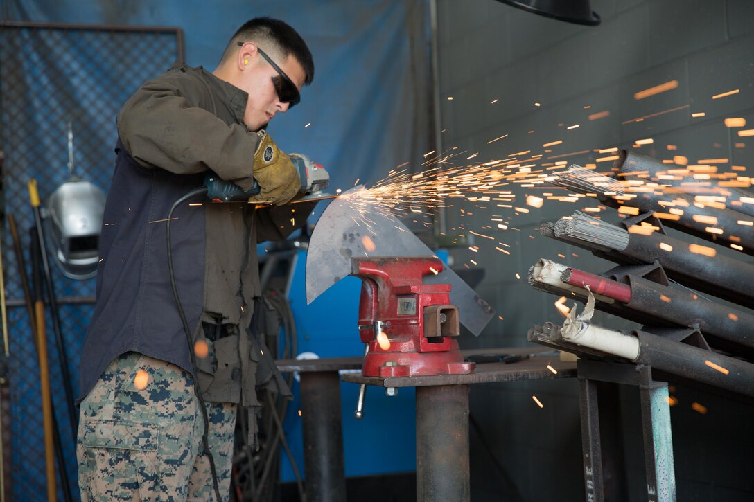 A U.S. Marine with 1st Light Armored Reconnaissance Battalion, 1st Marine Division, uses a grinder to repair a part for a High Mobility Multi-Purpose Wheeled Vehicle aboard Camp Pendleton, Calif., Dec. 4, 2017. The Marines are conducting routine maintenance in preparations for 1st Marine Division-led Exercise Steel Knight 2018.