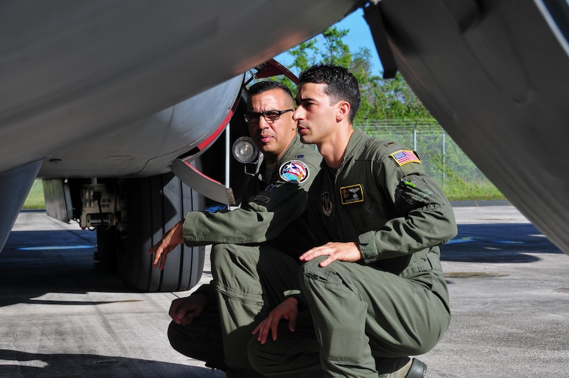 Air Force 2nd Lt. Isaias Rivera and Air Force Lt. Col. Evaristo Orengo, the 198th Airlift Squadron commander, conduct a pre-flight inspection before Rivera's first home base flight at Muniz Air National Guard Base, Puerto Rico, Nov. 22, 2017. Puerto Rico Air National Guard photo by Air Force Capt. Matt Murphy