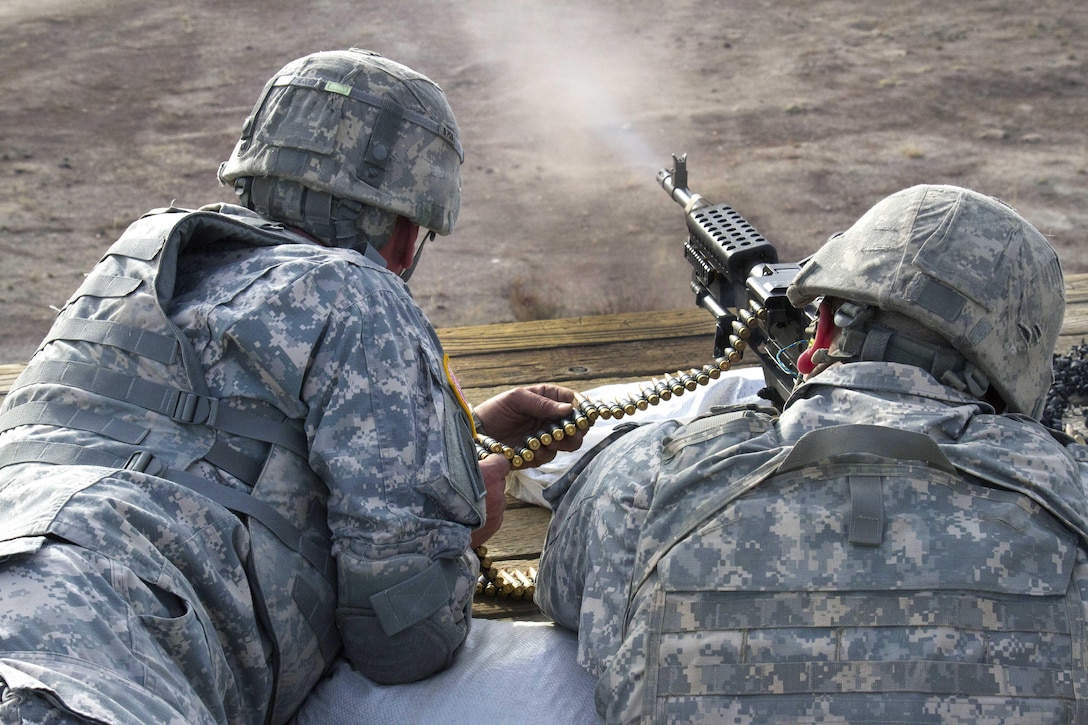 Spc. Benjamin Rowan, right, fires an M240B machine gun at a 400-meter target during Operation Cold Steel II.