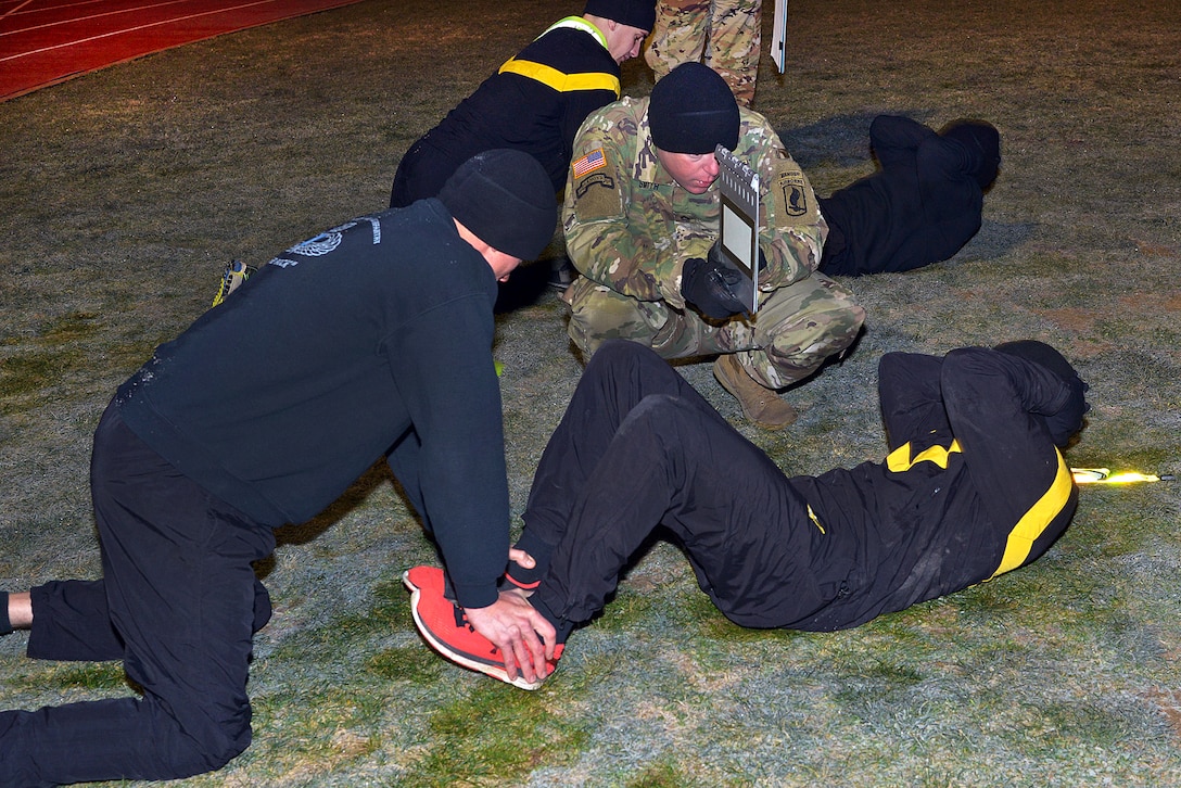 Soldiers participate in situps during physical training.