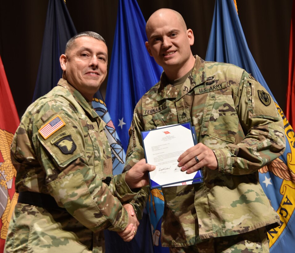 Army Staff Sgt. William Fernandez is recognized as DLA’s Non-Commissioned Officer of the Quarter, fourth quarter, fiscal year 2017 by DLA Distribution commander Army Brig. Gen. John S. Laskodi.
