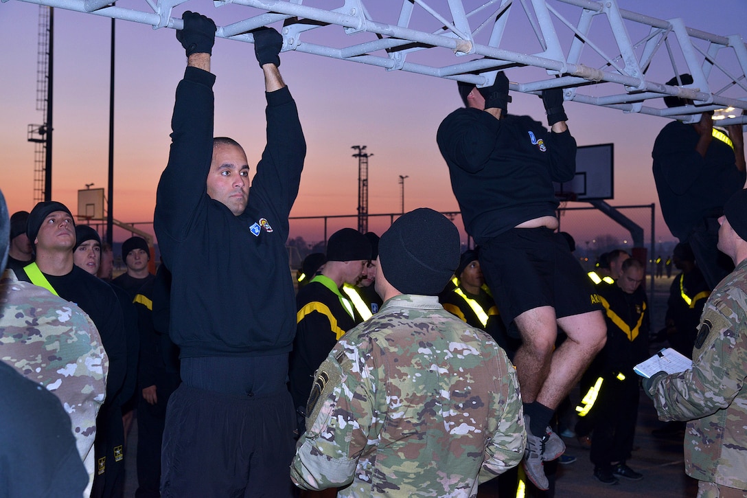 Soldiers participate in the pull-up event during physical training.