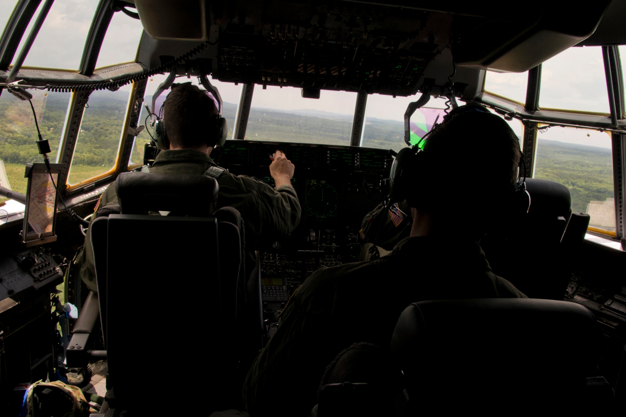 U.S. Air Force Reserve Aircrew members scan the Arkansas countryside during a training flight in a C-130J Super Hercules June 15, 2017, near Little Rock Air Force Base, Ark. They were part of the 913th Airlift Group’s first 3-ship mission manned entirely by Reserve Airmen. (U.S. Air Force photo by Master Sgt. Jeff Walston/Released)