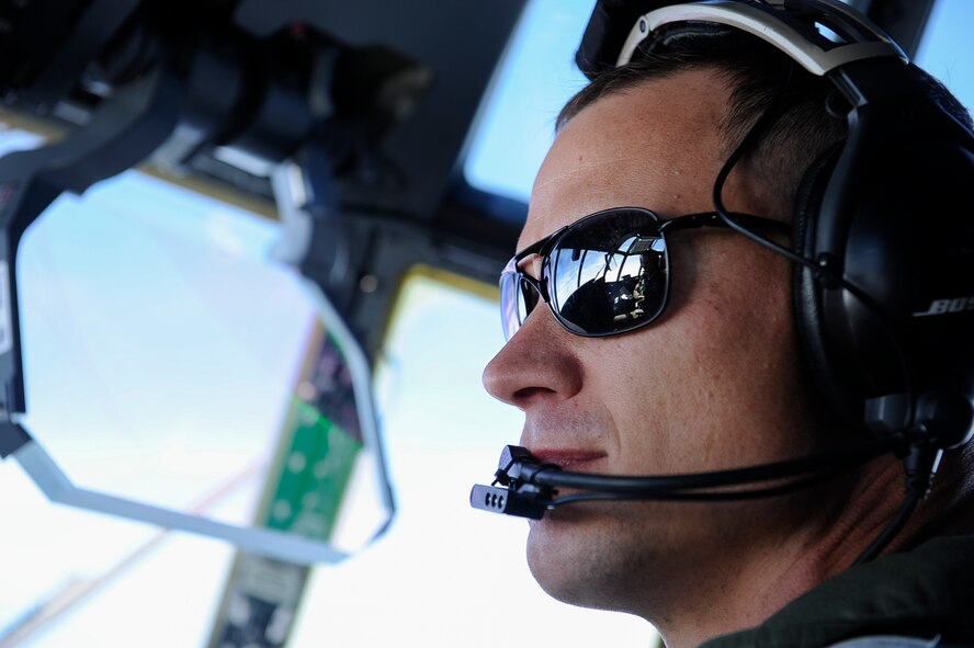 U.S. Air Force Maj. Kyle Bucher, 37th Airlift Squadron C-130J Super Hercules pilot, looks out while flying a C-130J to Dyess Air Force Base, Texas, Nov. 29, 2017. The C-130J, an upgraded version of the C-130 Hercules legacy model, adds 15 feet to the fuselage and increases usable space in the cargo compartment. The new aircraft replaces one of 14 C-130J’s in Ramstein’s fleet, helping avoid potential problems with the Air Force’s aging fleet. (U.S. Air Force photo by Airman 1st Class Savannah L. Waters)