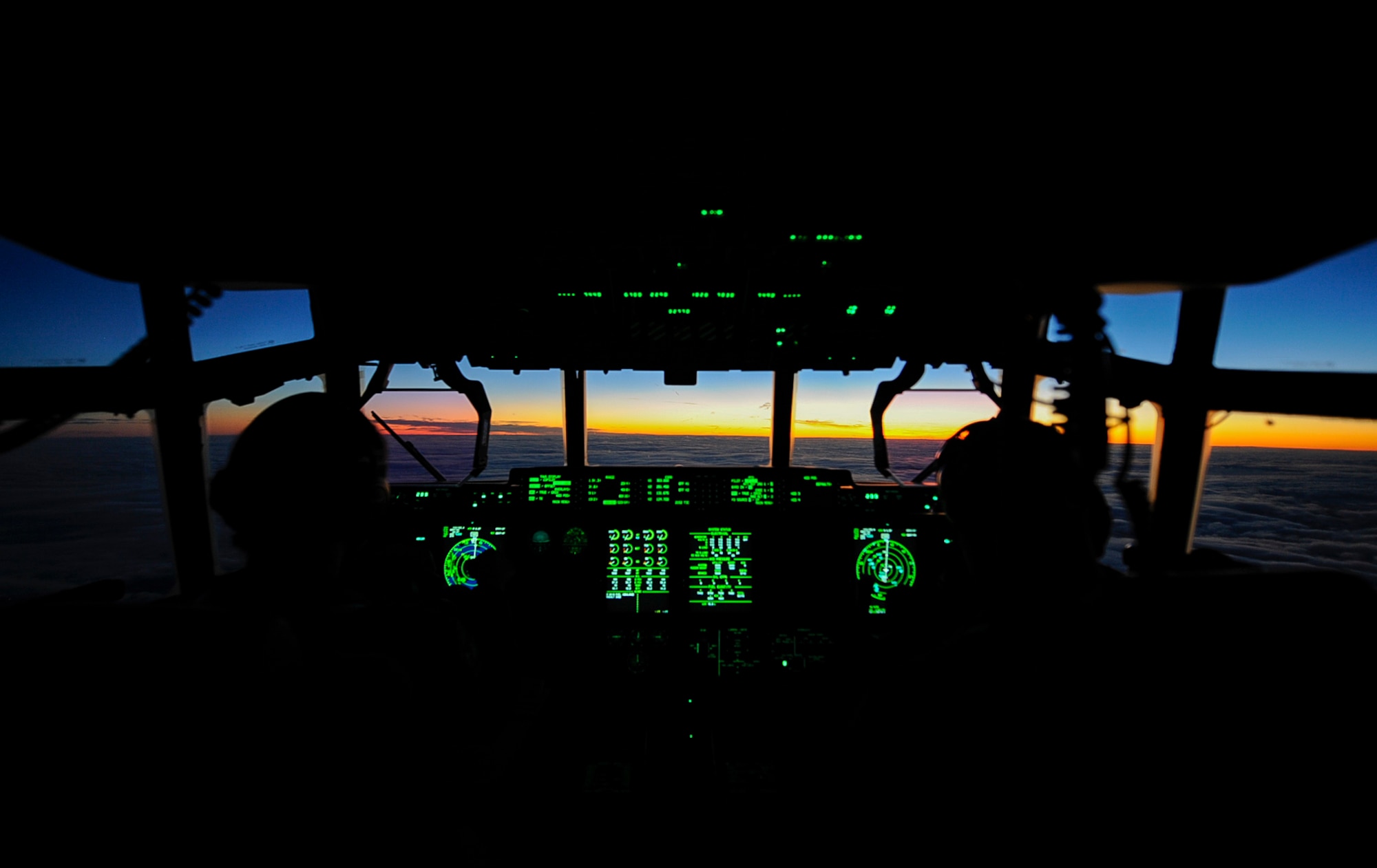 U.S. Air Force 1st Lt. Melinda Marlow (left), and Maj. Kyle Bucher (right), 37th Airlift Squadron C-130J Super Hercules pilots, fly a C-130J over Shannon, Ireland, during the sunrise Dec. 4, 2017. A crew assigned to the 37th Airlift Squadron crossed the Atlantic Ocean to retrieve a brand new C-130J Super Hercules from the Lockheed Martin Aeronautics Company production facility, in Marietta, Georgia, Nov. 29. (U.S. Air Force photo by Airman 1st Class Savannah L. Waters)
