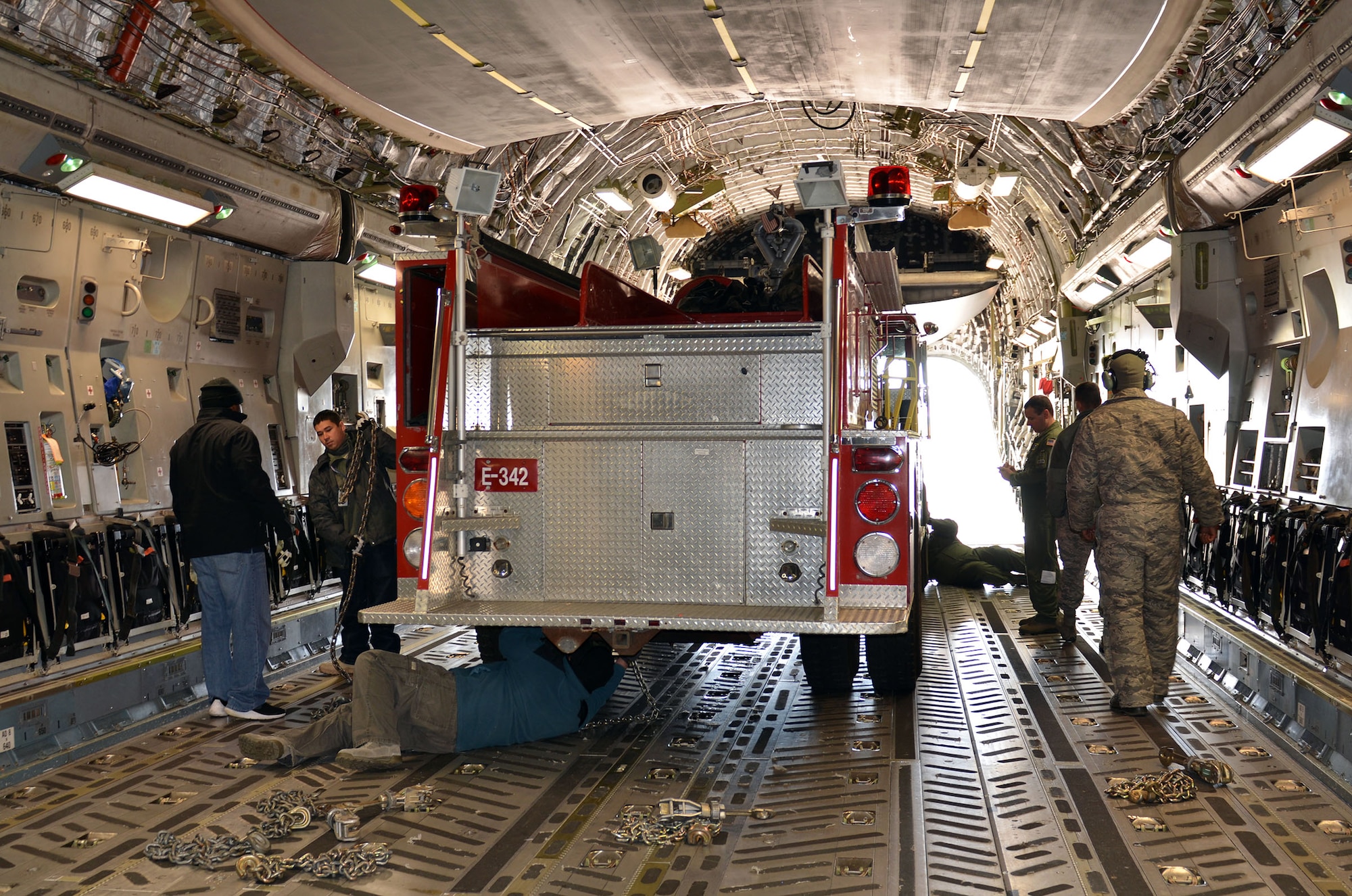 Loadmasters from the 89th Airlift Squadron load a fire truck on a 445th Airlift Wing C-17 Globemaster III Nov. 8, 2017. The wing received a request through the Denton Program to move a fire truck from Ohio to Belize City, Belize.